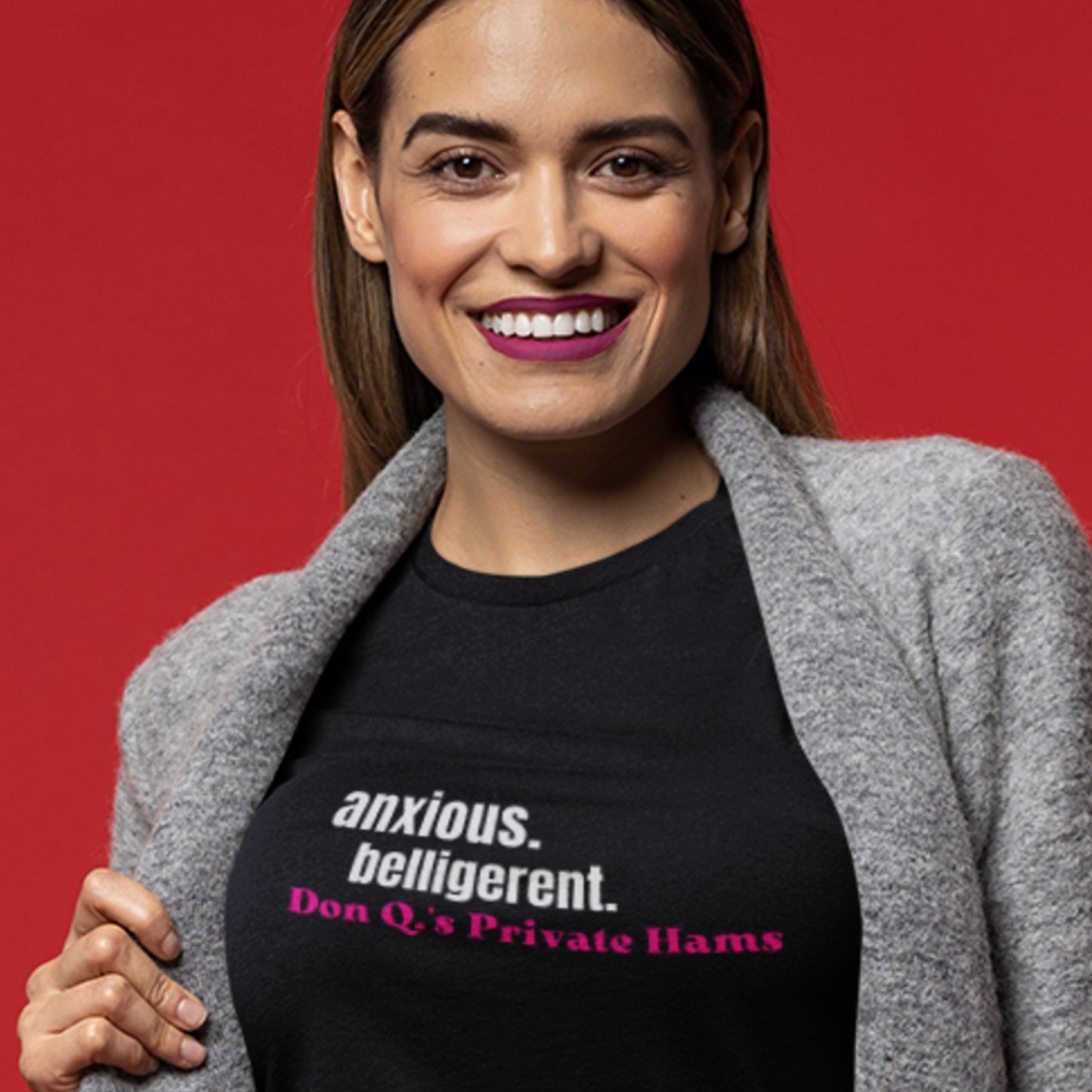 Woman wearing a black t-shirt with text on a red background.