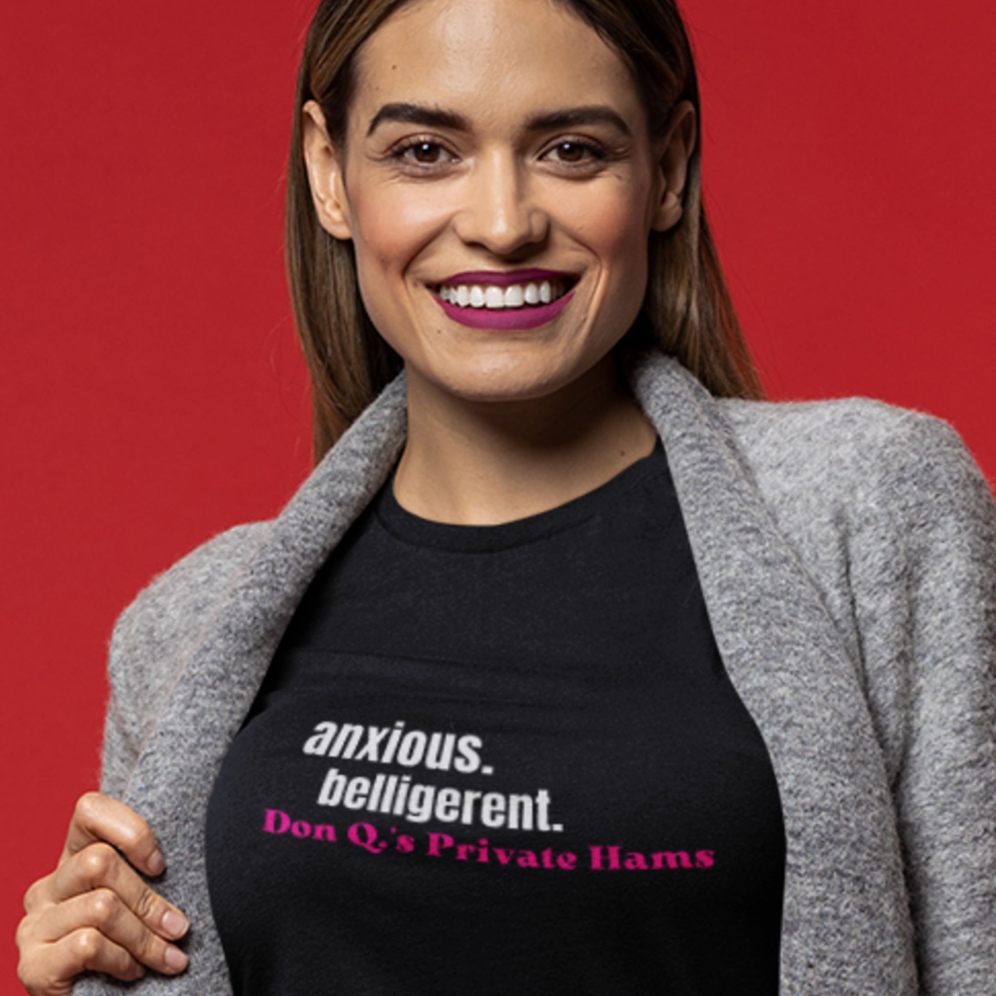 Woman wearing a black t-shirt with text on a red background.