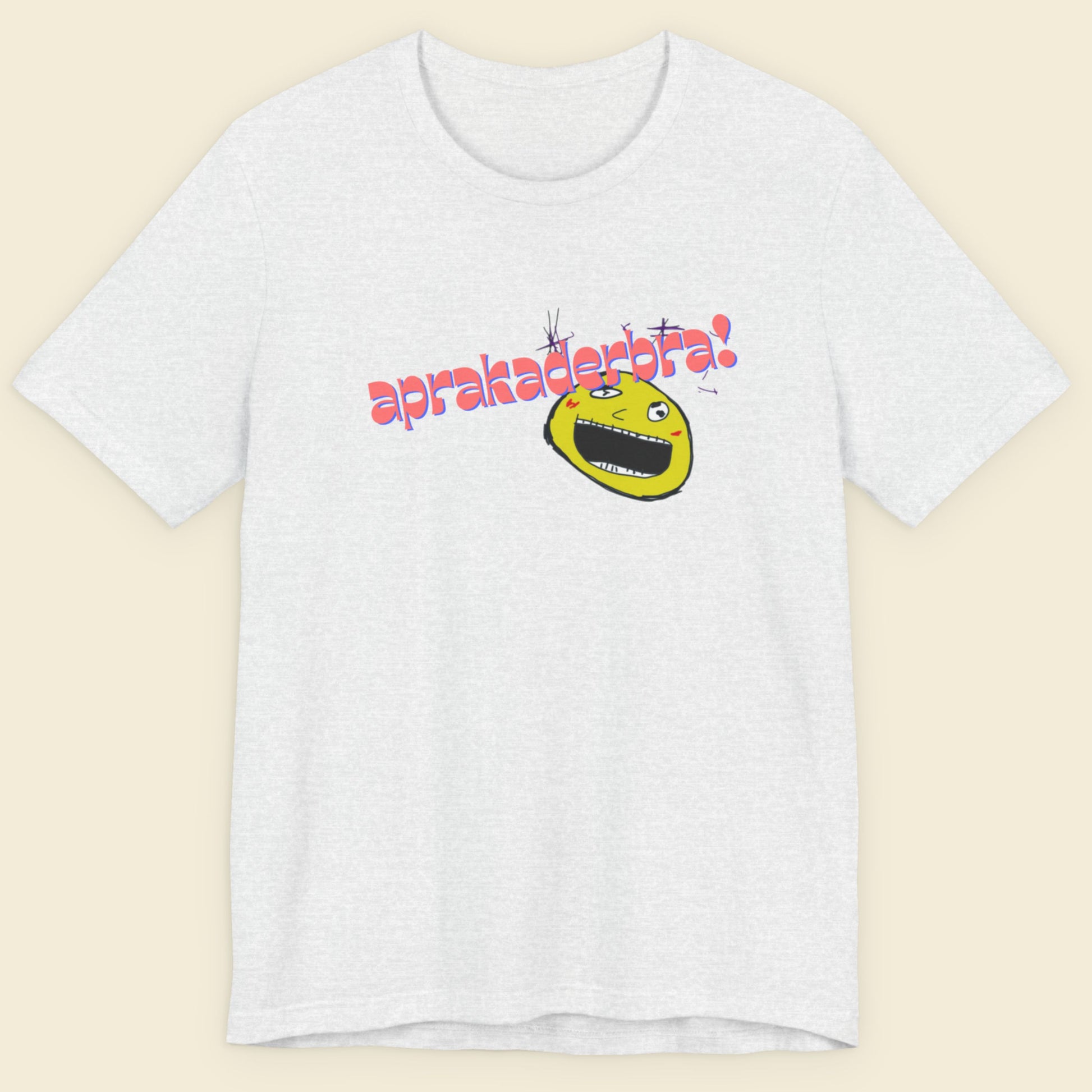 Ash grey t-shirt with a fun, colorful cartoon illustration on a beige background.