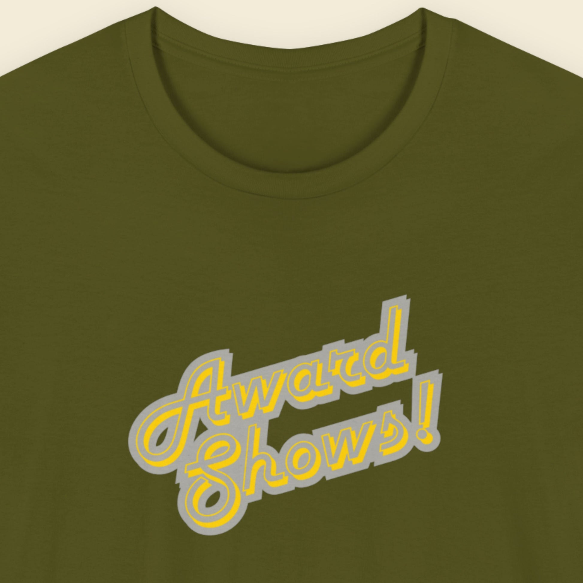 Green t-shirt with yellow and grey stylized text on a beige background.