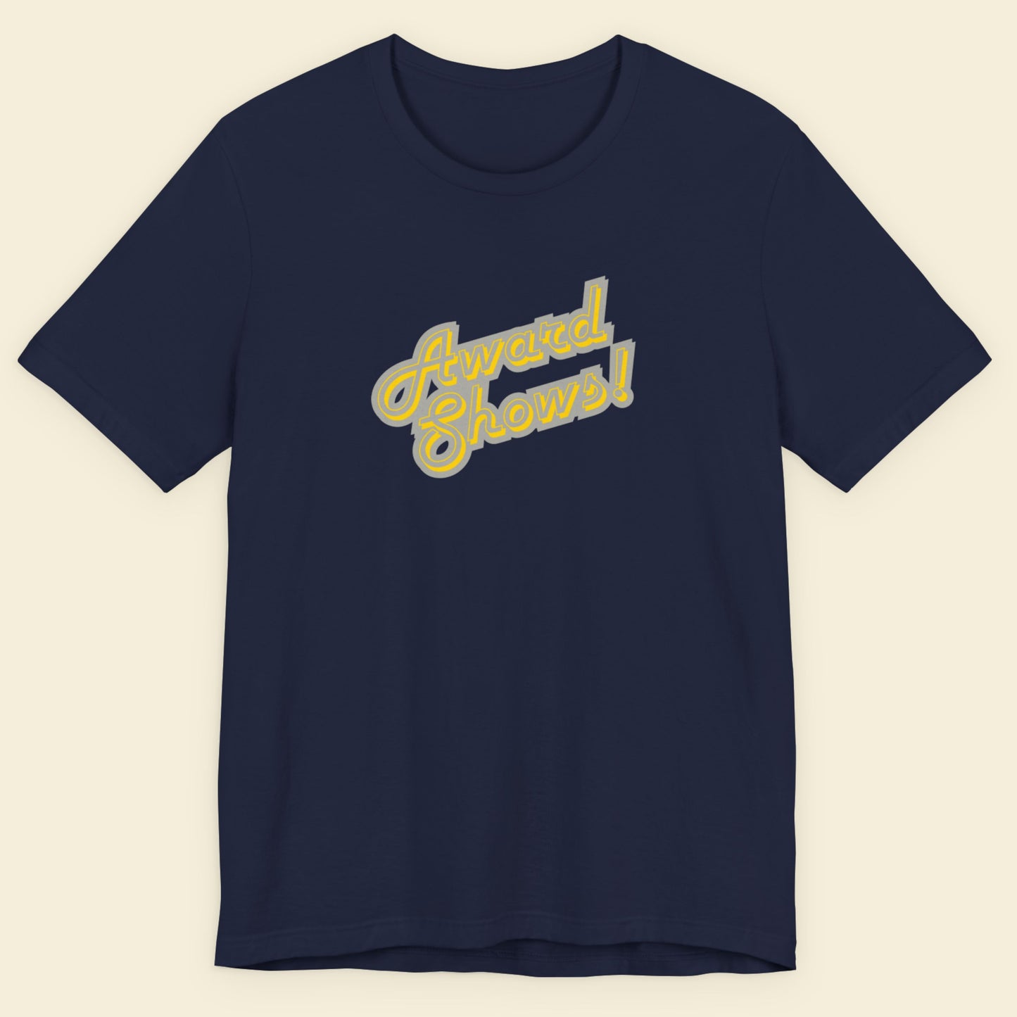 Navy t-shirt with yellow and grey stylized text on a beige background.