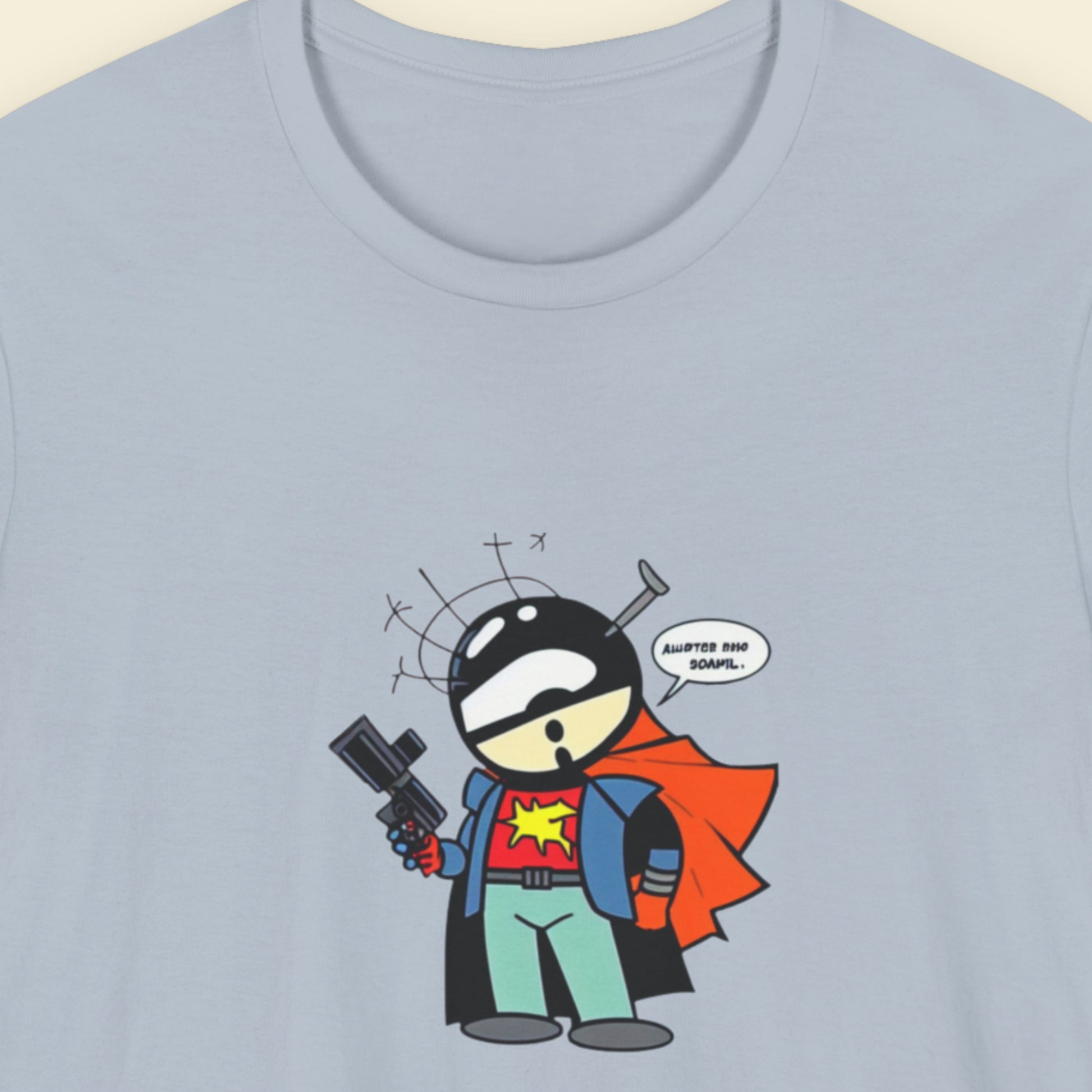 Light blue shirt with a fun, colorful cartoon illustration on a beige background.