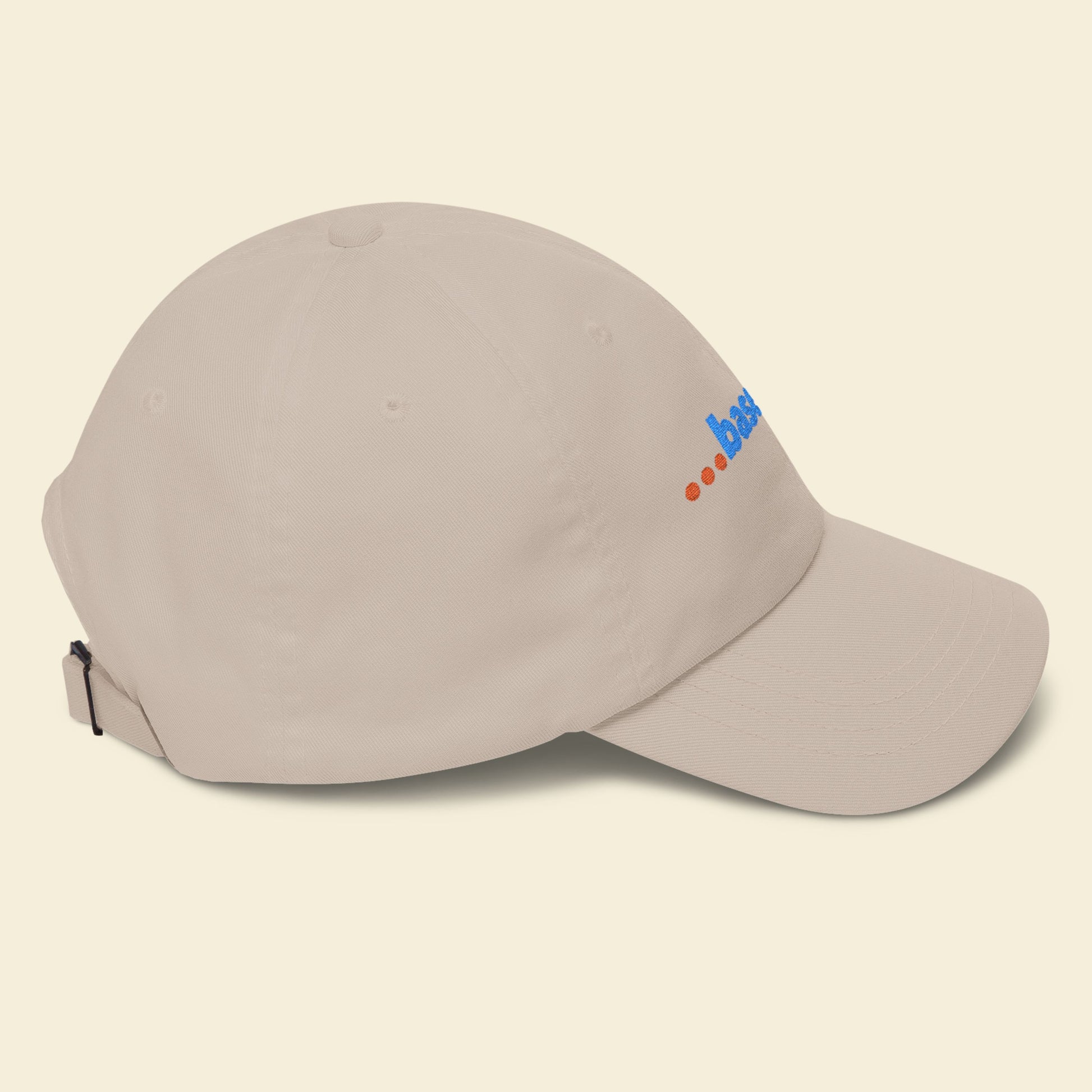 Beige cap with a logo on a beige background.