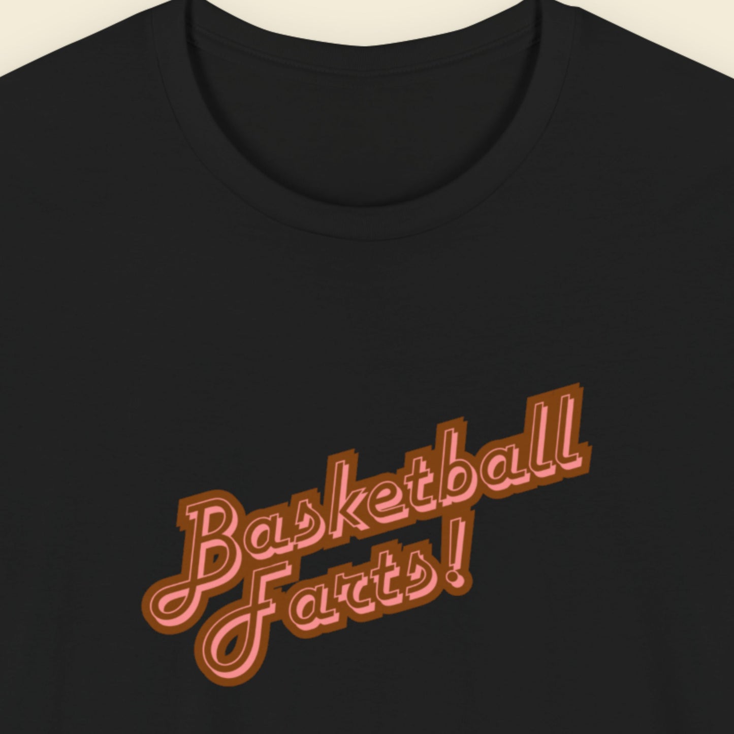 Black t-shirt with two-tone red text reading 'Basketball Farts!' on a beige background.