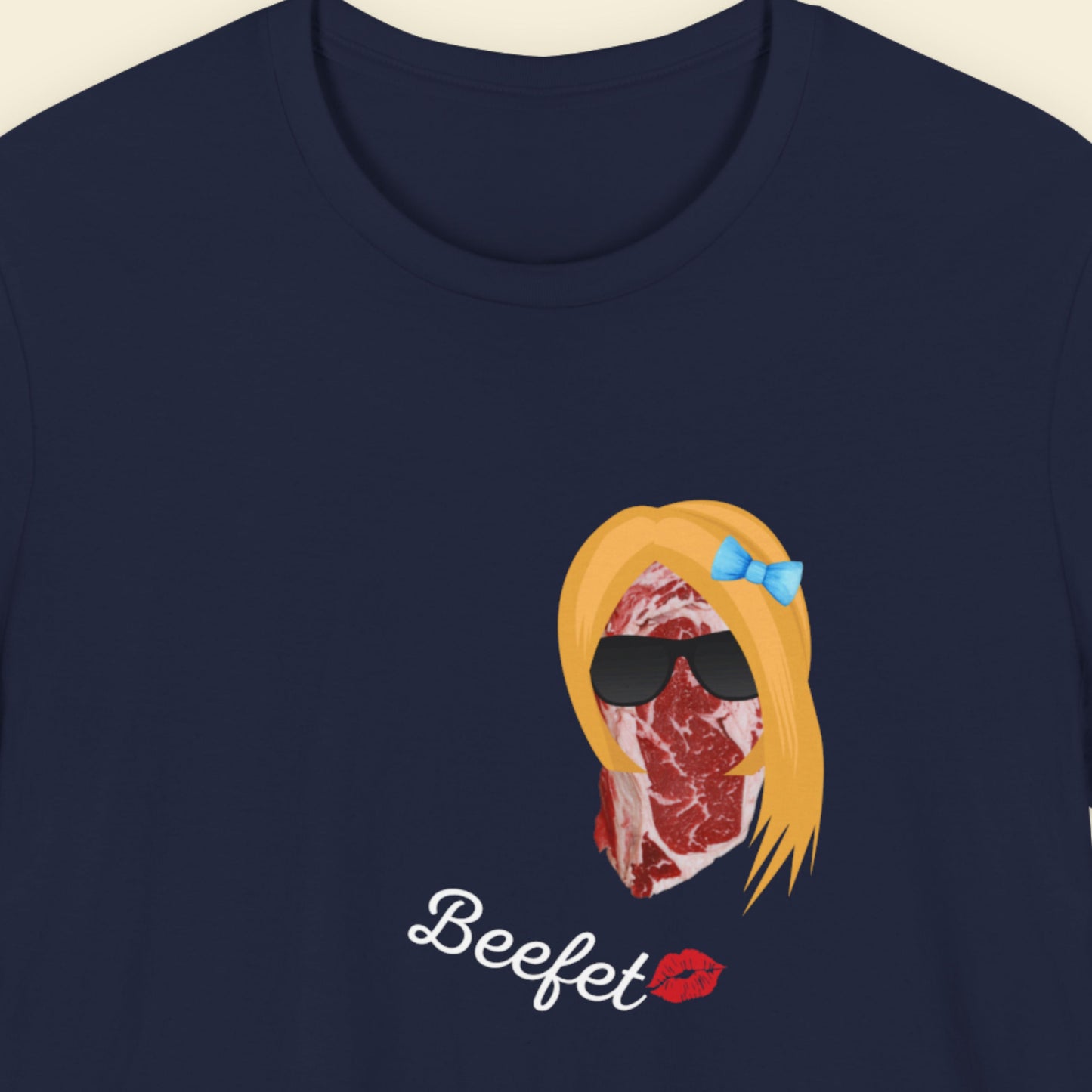 Navy blue t-shirt with a fun, colorful beef illustration on a beige background.