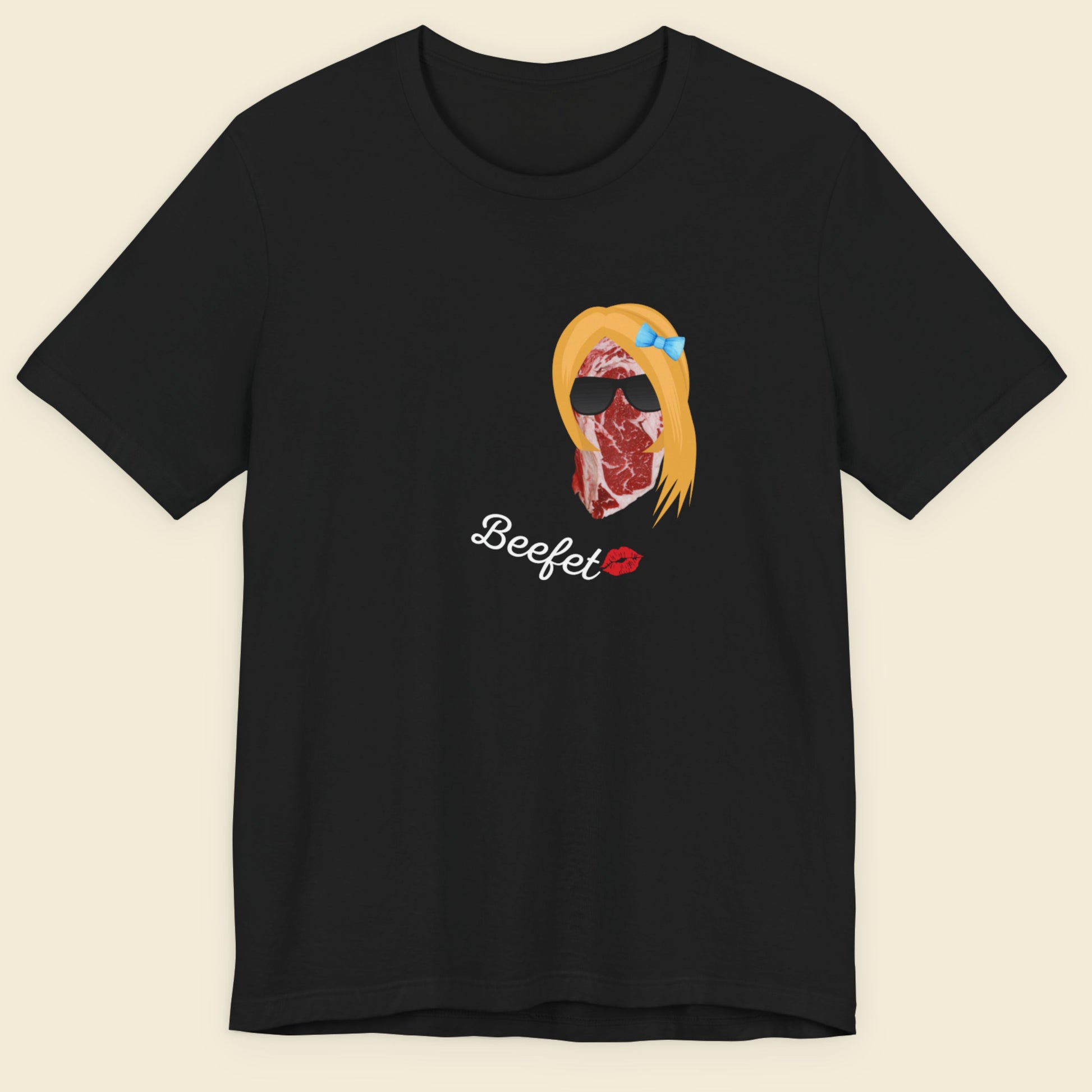 Black t-shirt with a graphic design of a woman's face made of beef and the word 'Beefet' on a beige background.