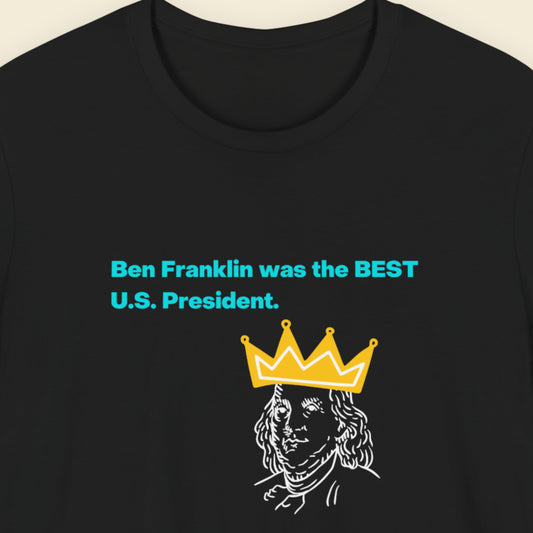 Black t-shirt with humorous colorful text on a beige background.