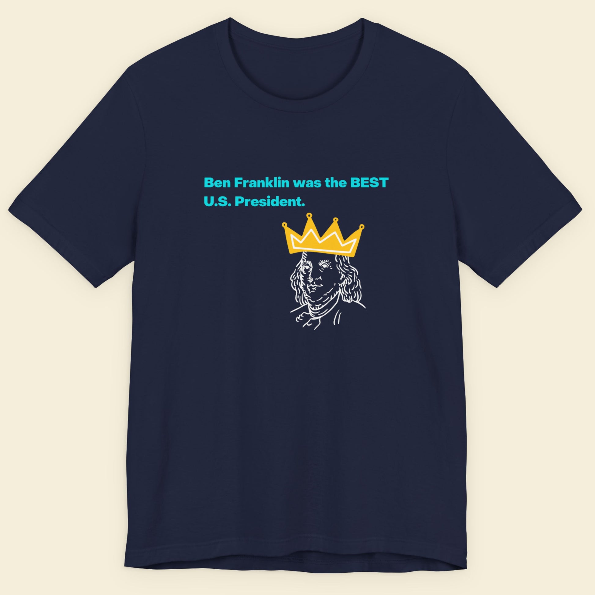 Navy blue t-shirt with graphic of Benjamin Franklin wearing a crown and text on a beige background.