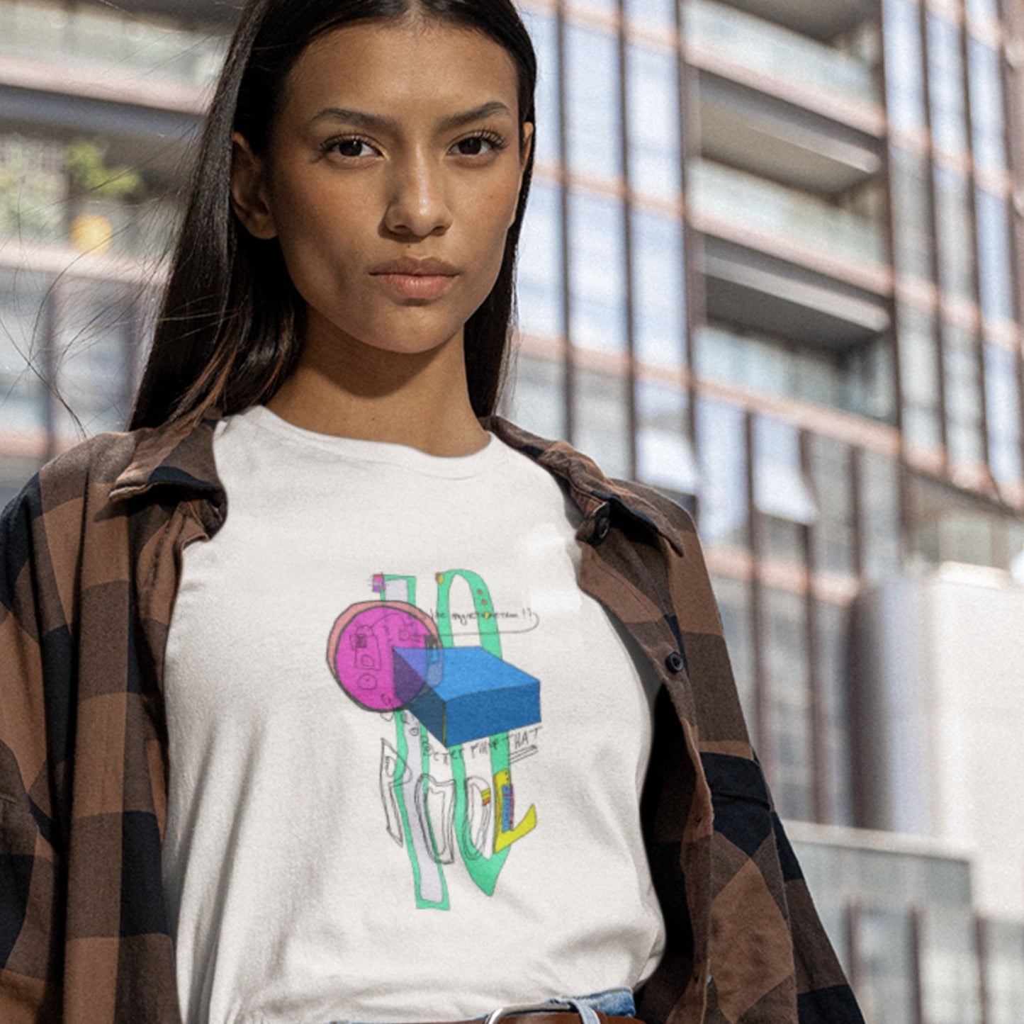 Woman wearing a white t-shirt with a colorful abstract drawing in a city.