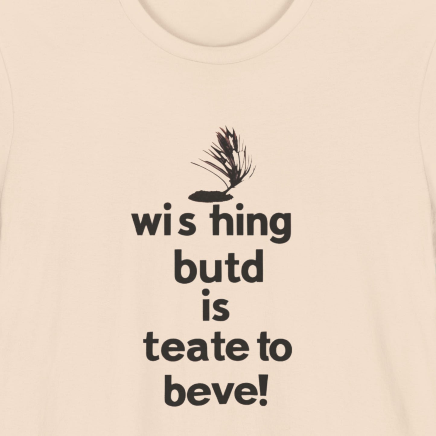 Beige t-shirt with humorous text on a beige background.