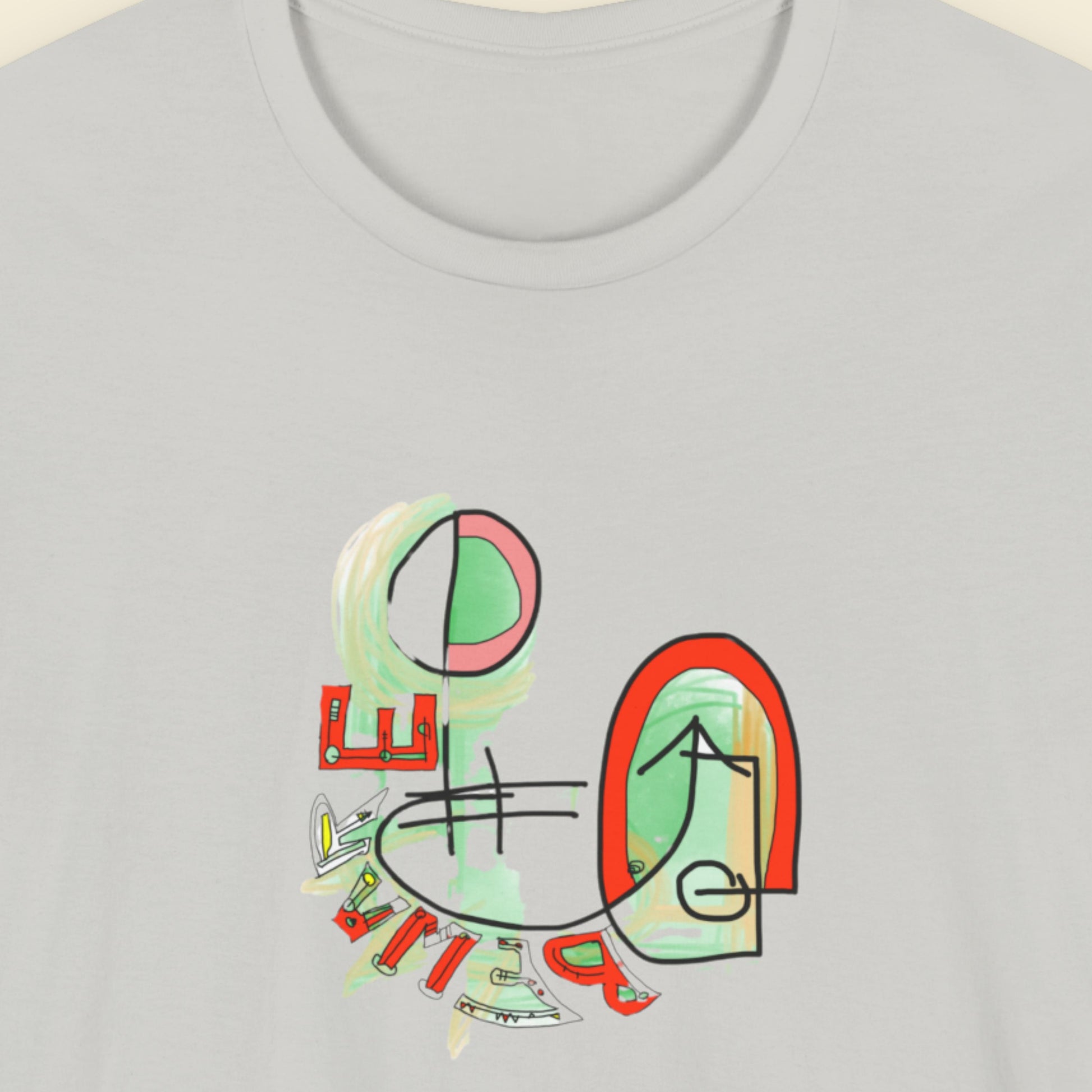 Grey t-shirt with a colorful abstract drawing on a beige background.
