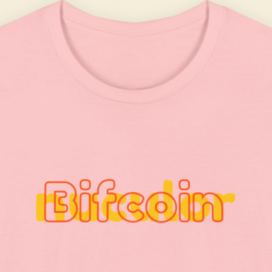 Pink t-shirt with humorous colorful text on a beige background.