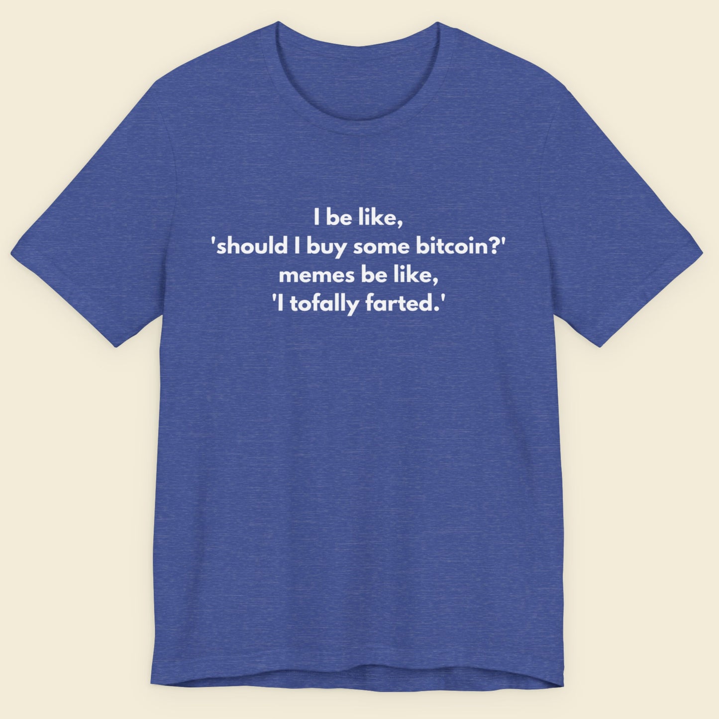 Heather blue t-shirt with humorous text on a beige background.