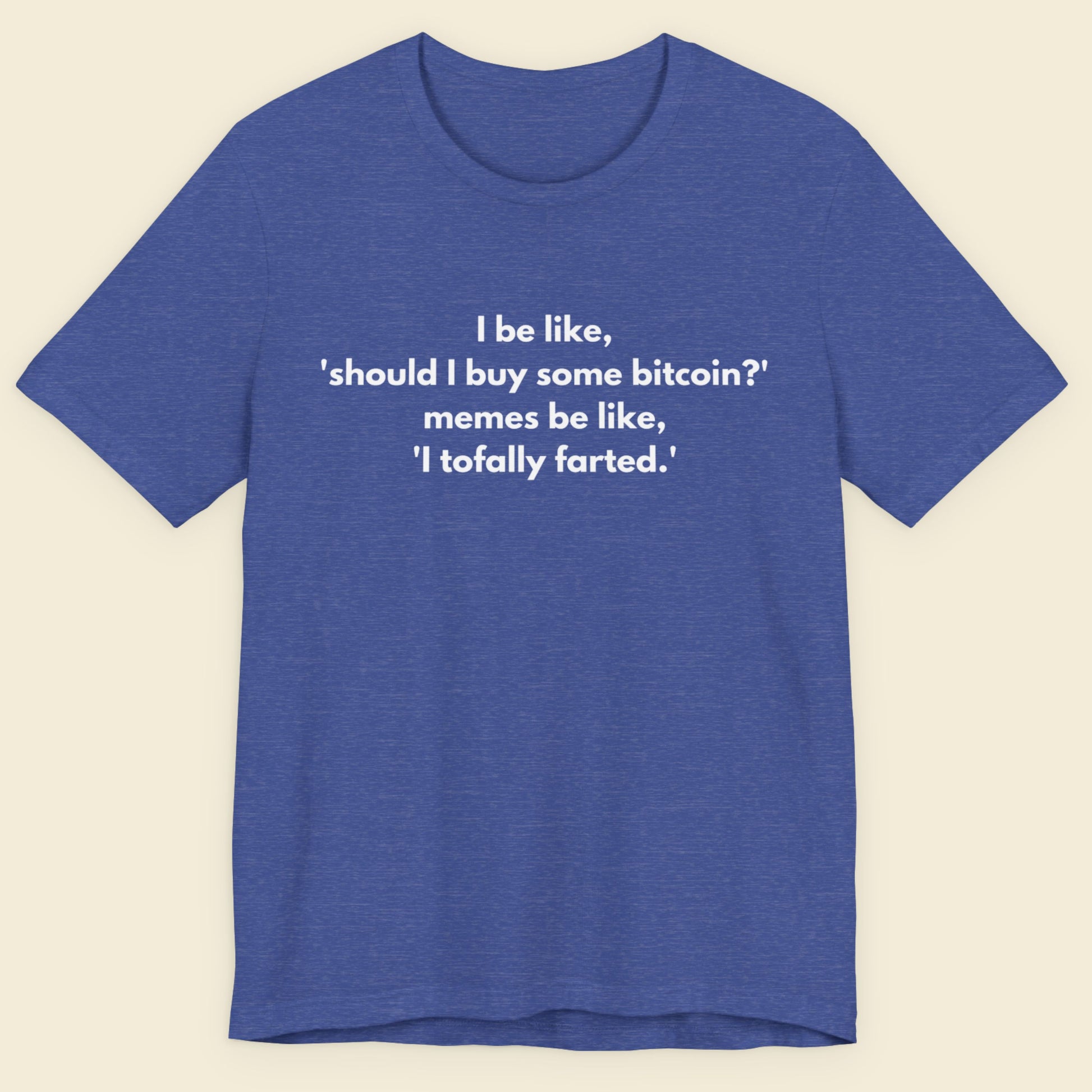 Heather blue t-shirt with humorous text on a beige background.