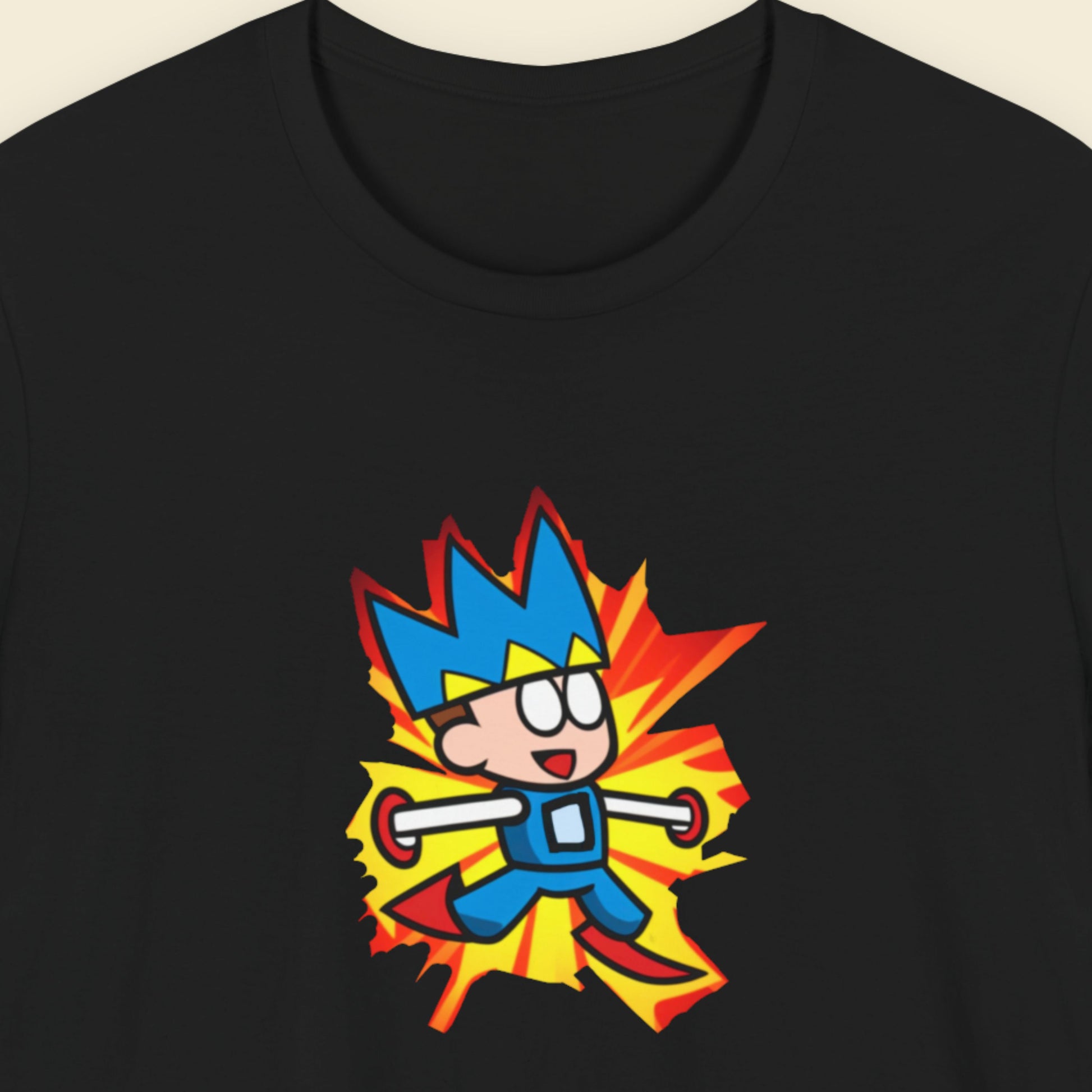 Black t-shirt with a fun, colorful cartoon illustration on a beige background.