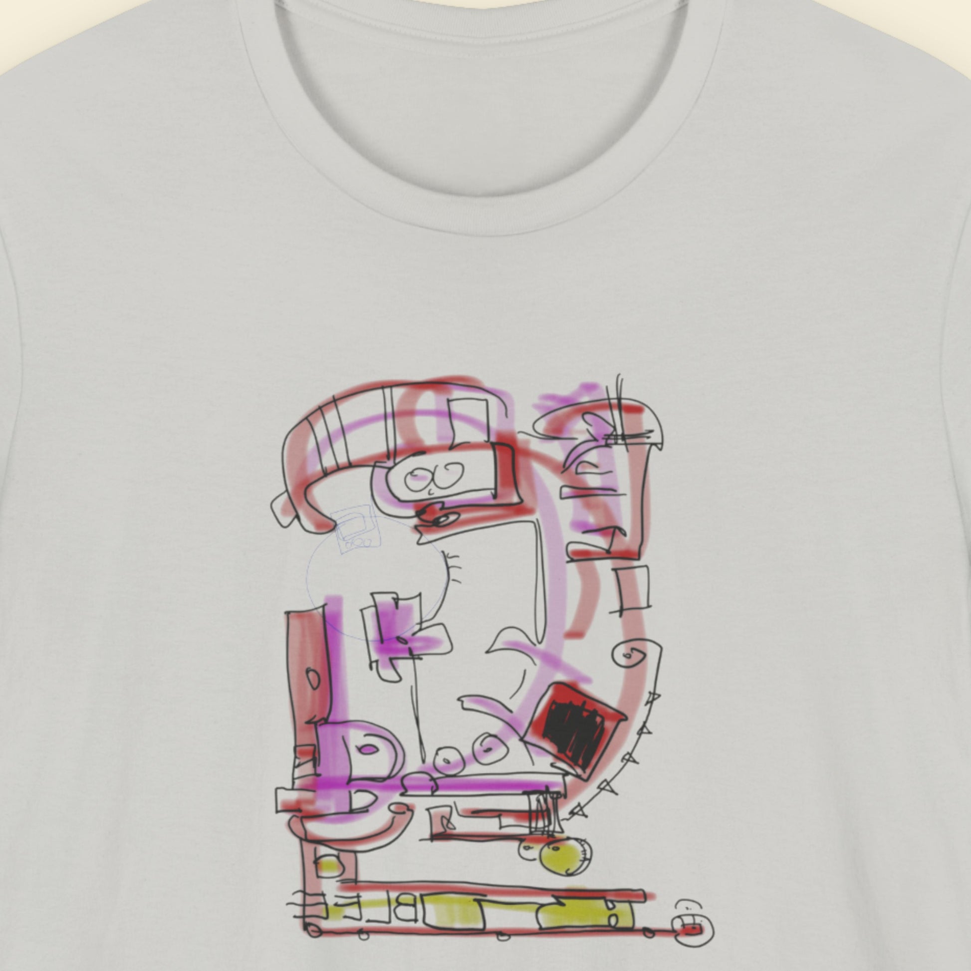 Grey t-shirt with a colorful abstract drawing on a beige background.