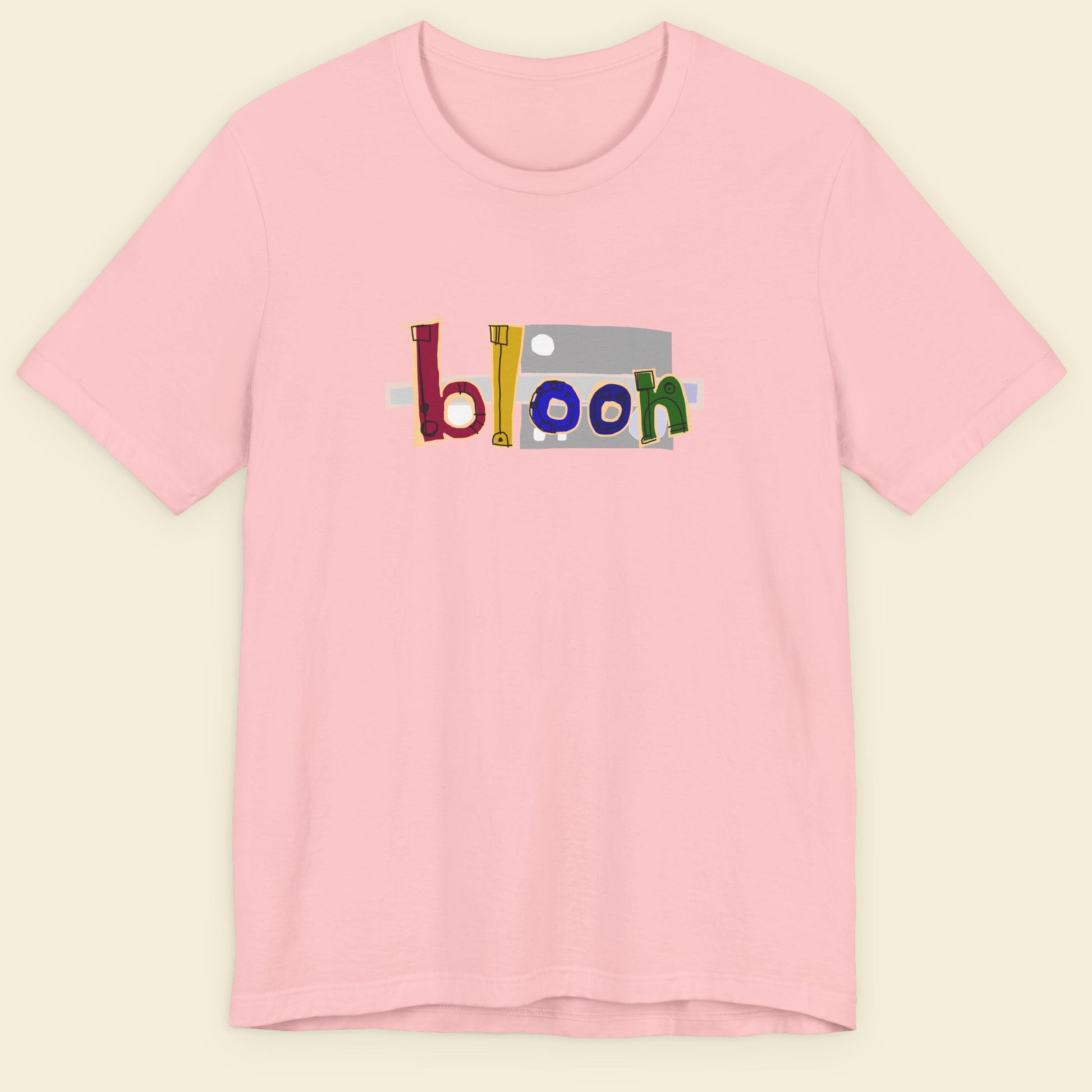 Pink t-shirt with colorful 'bloon' logo on a beige background.