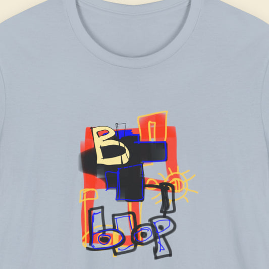Blue t-shirt with a colorful abstract drawing on a beige background.