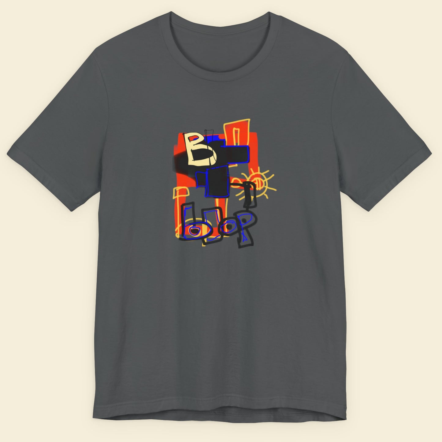 Grey t-shirt with a colorful abstract drawing on a beige background.