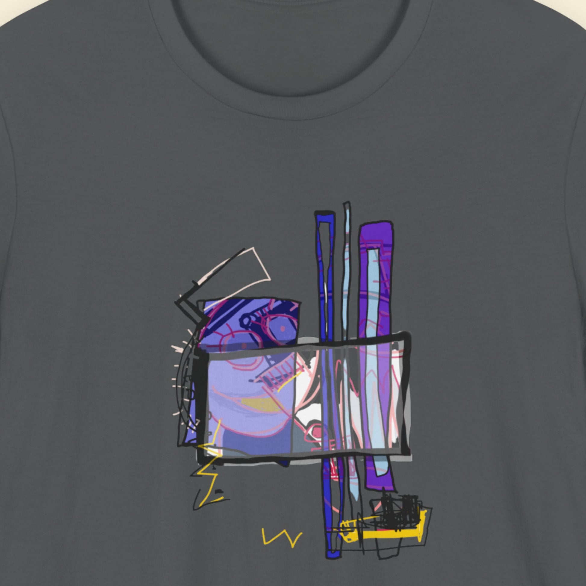 Dark grey t-shirt with a colorful abstract drawing on a beige background.