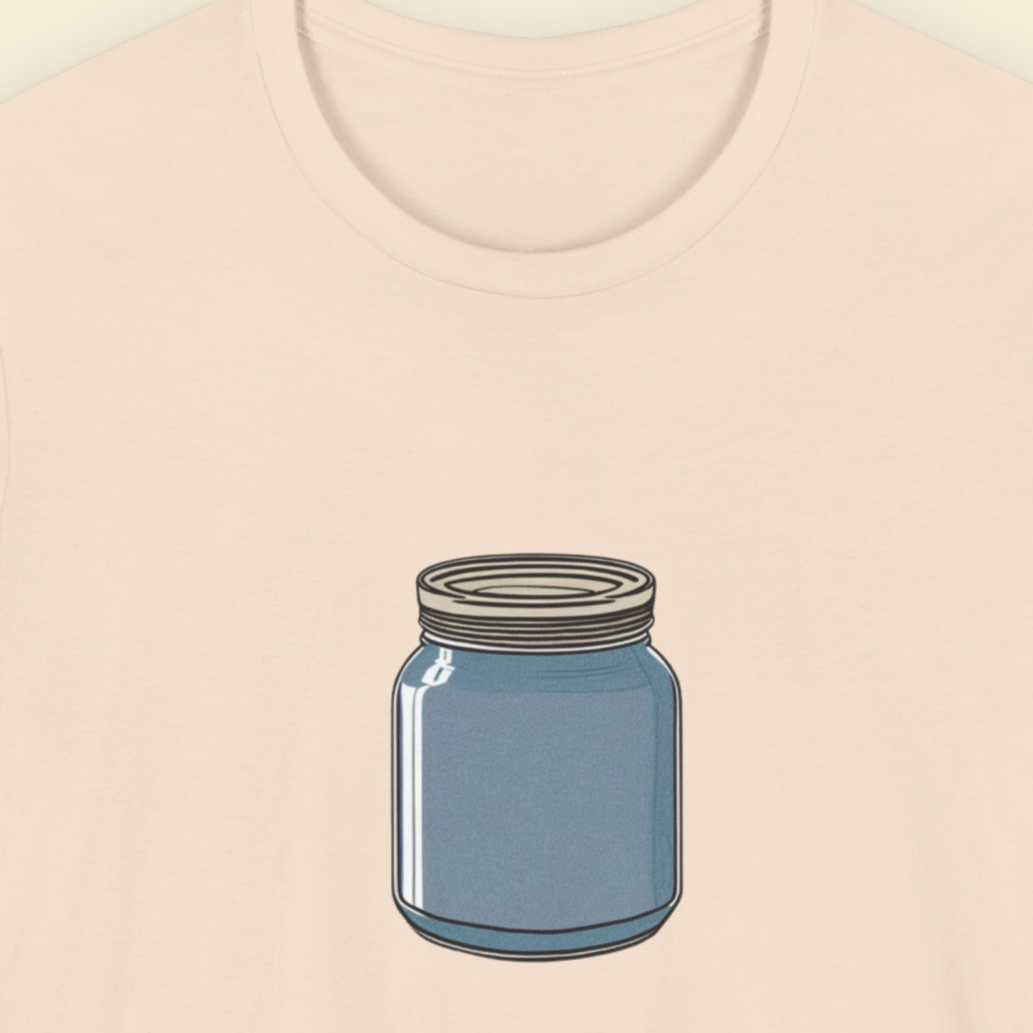Beige t-shirt with a drawing of a blue mason jar on a beige background.