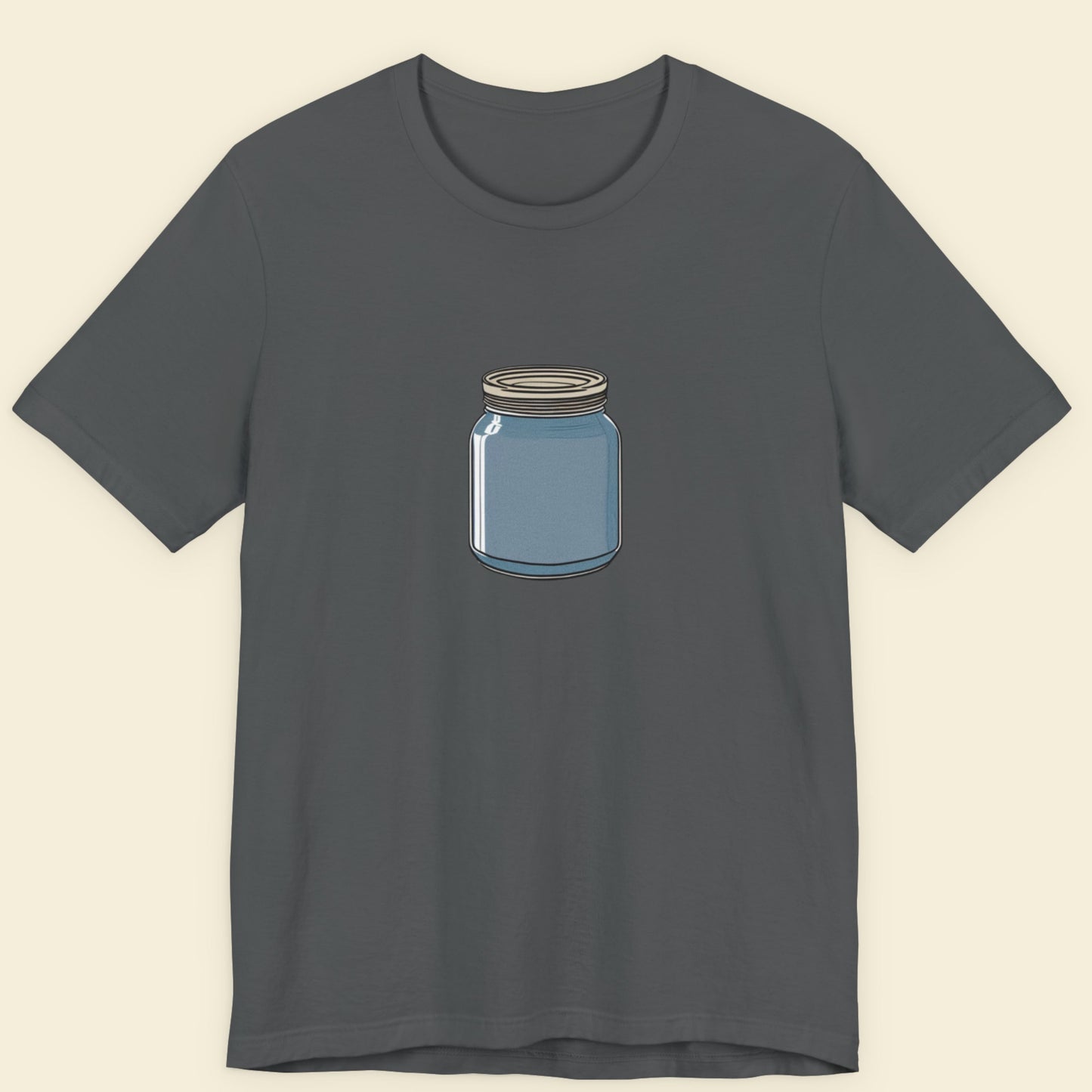 Grey t-shirt with a drawing of a blue mason jar on a beige background.
