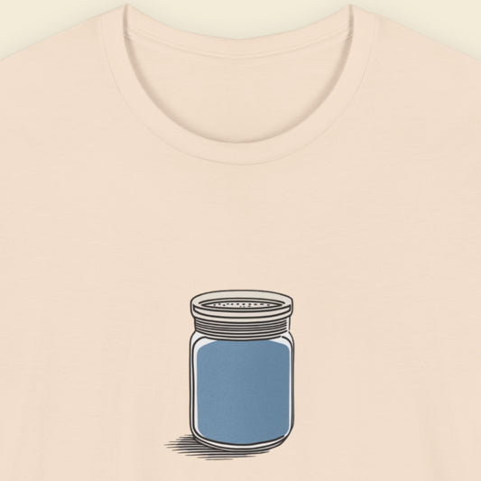 Beige shirt with a drawing of a blue shaker jar on a beige background.