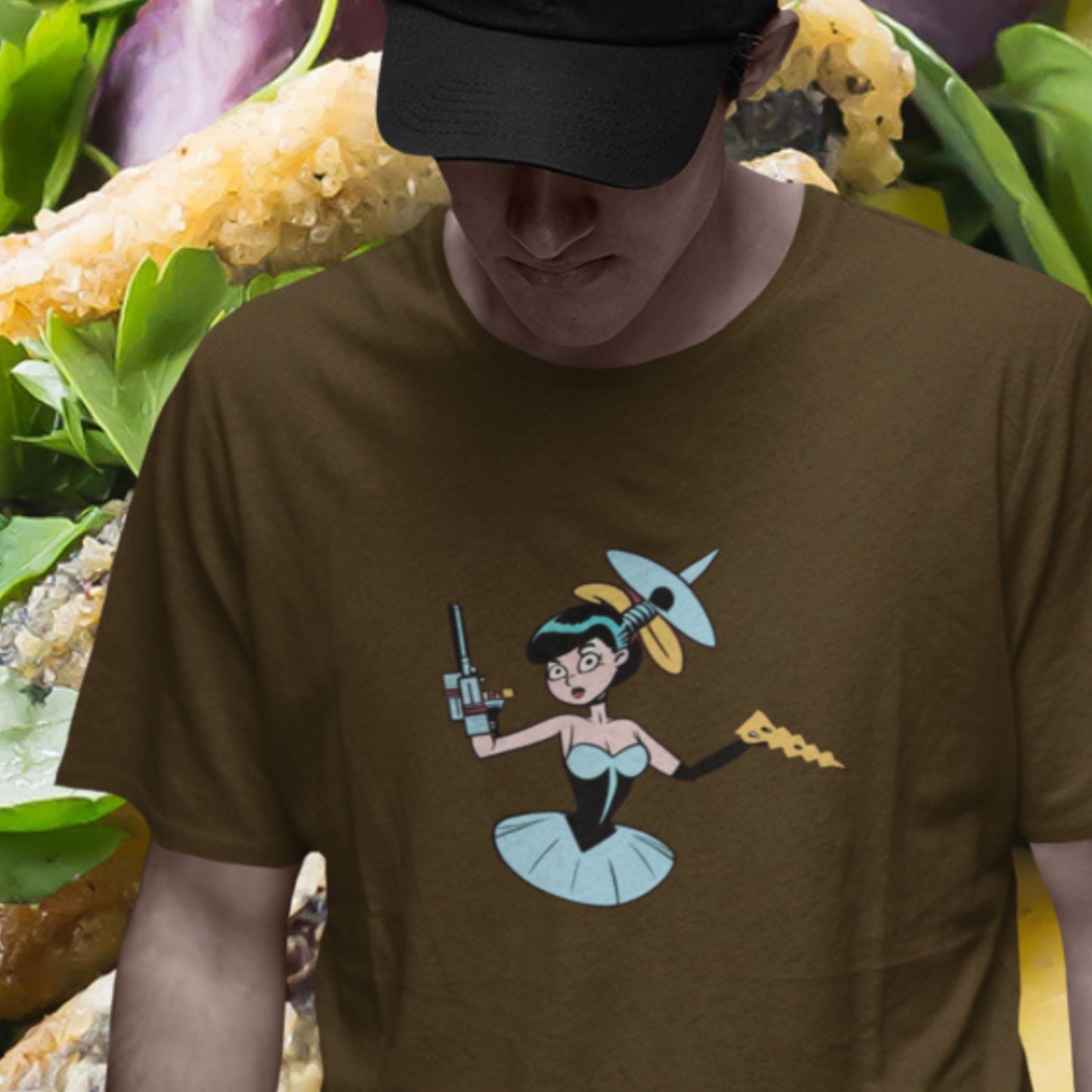 Man wears a brown shirt with a fun, colorful cyborg cartoon illustration in front of a giant salad.