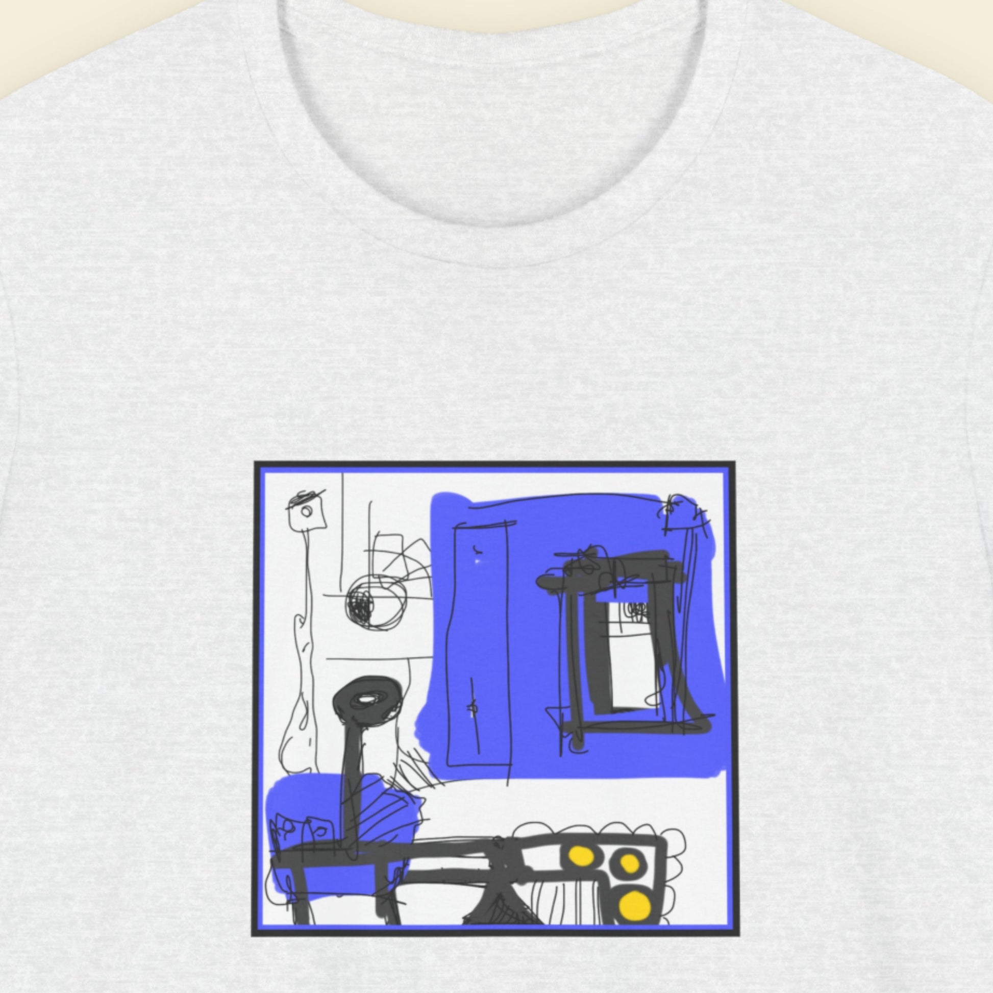 Ash grey t-shirt with a colorful abstract drawing on a beige background.