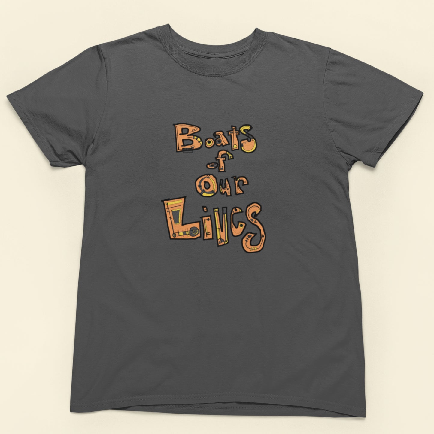 Gray t-shirt with 'Boats of Our Lives' text design on a beige background