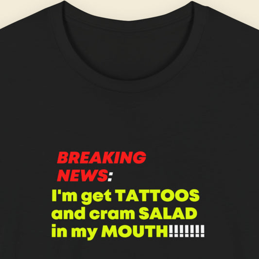 Black t-shirt with colorful text on a beige background.