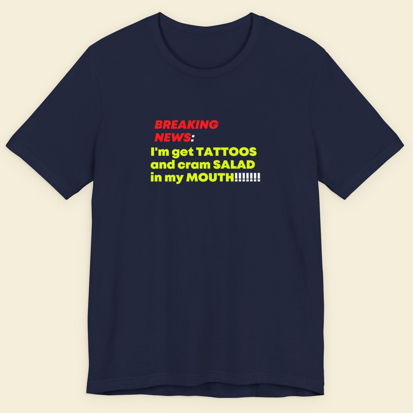 Navy blue t-shirt with colorful text on a beige background.