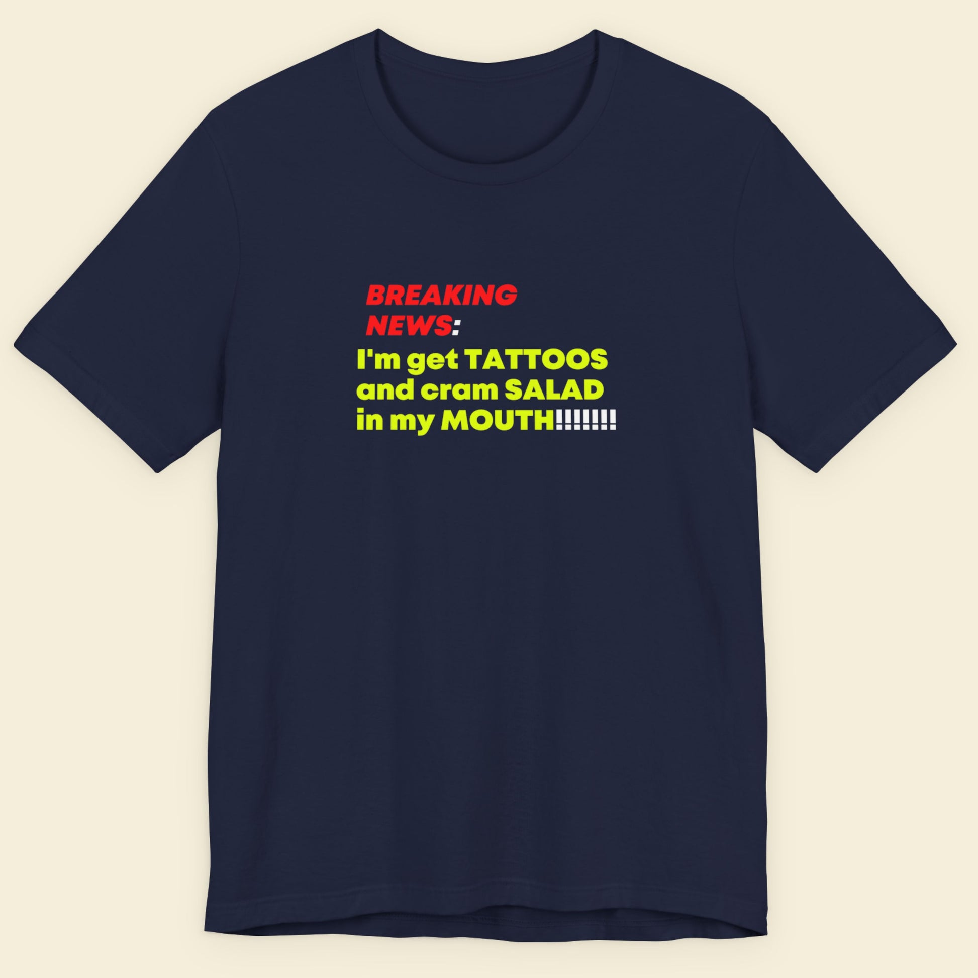 Navy blue t-shirt with colorful text on a beige background.