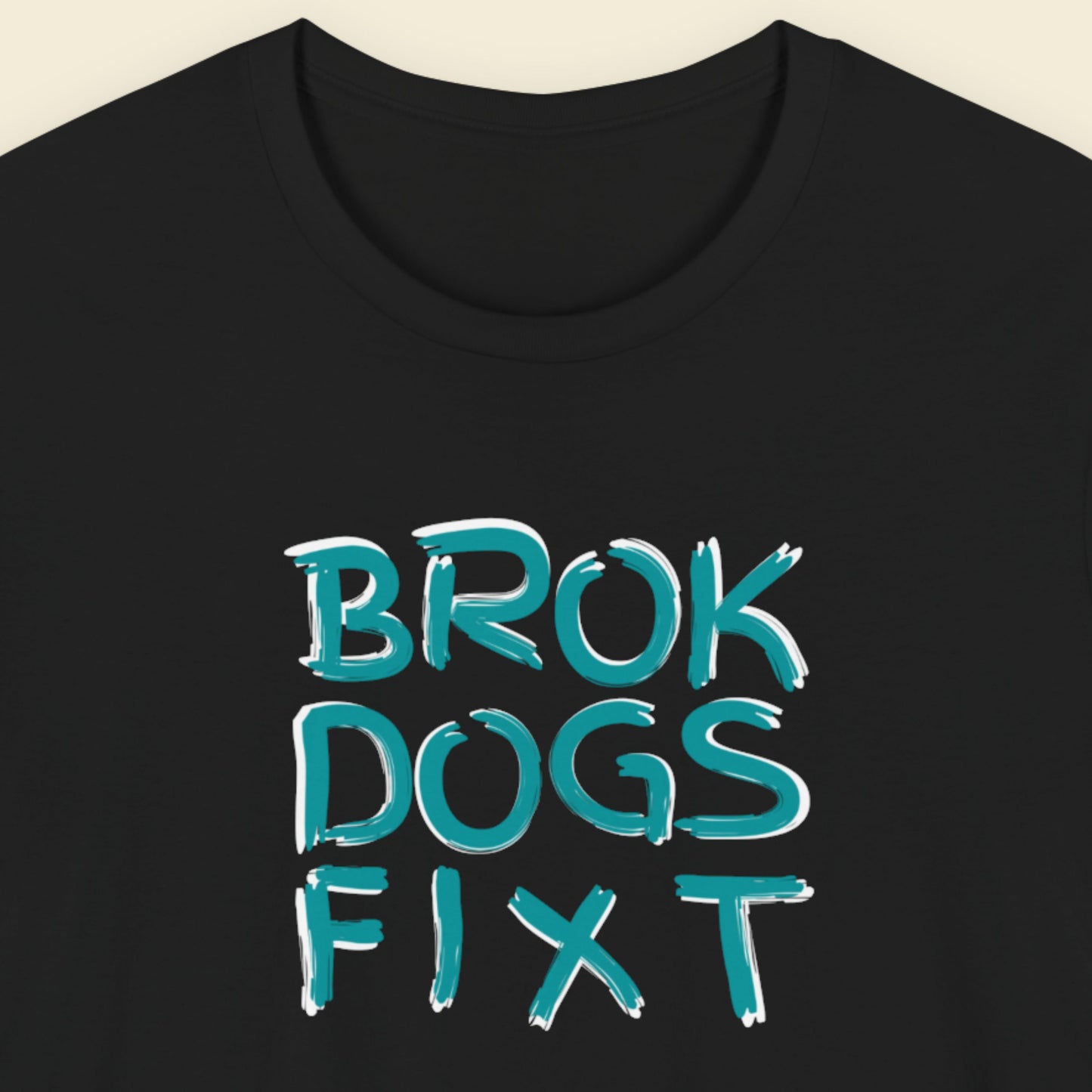 Black t-shirt with teal text 'BROK DOGS FIXT' on a beige background.