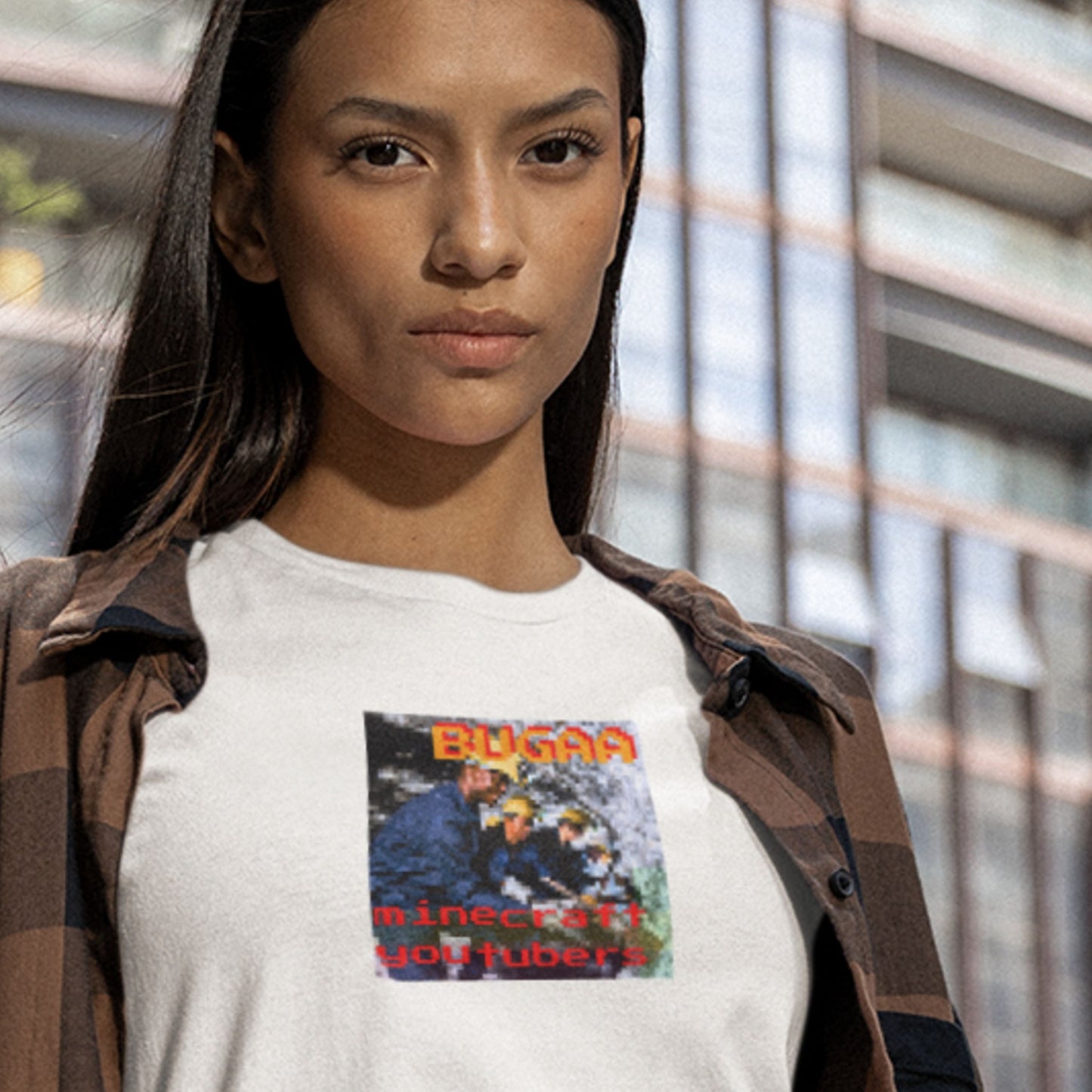 Person wearing a white t-shirt with a graphic design in an urban setting