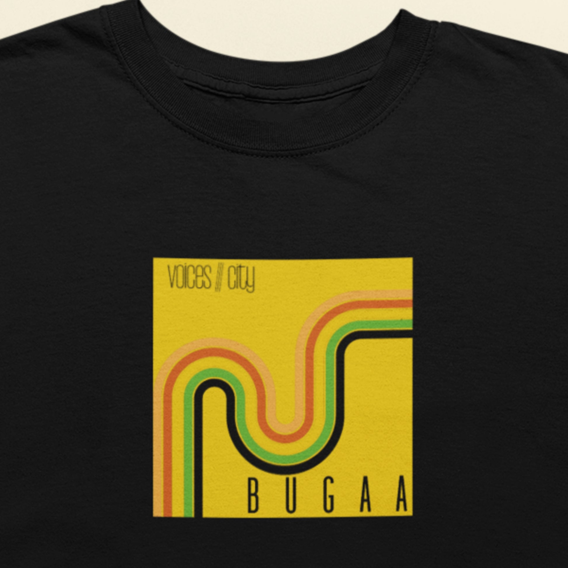 Black t-shirt with a yellow graphic design featuring the text 'Voices///City' and 'BUGAA'.