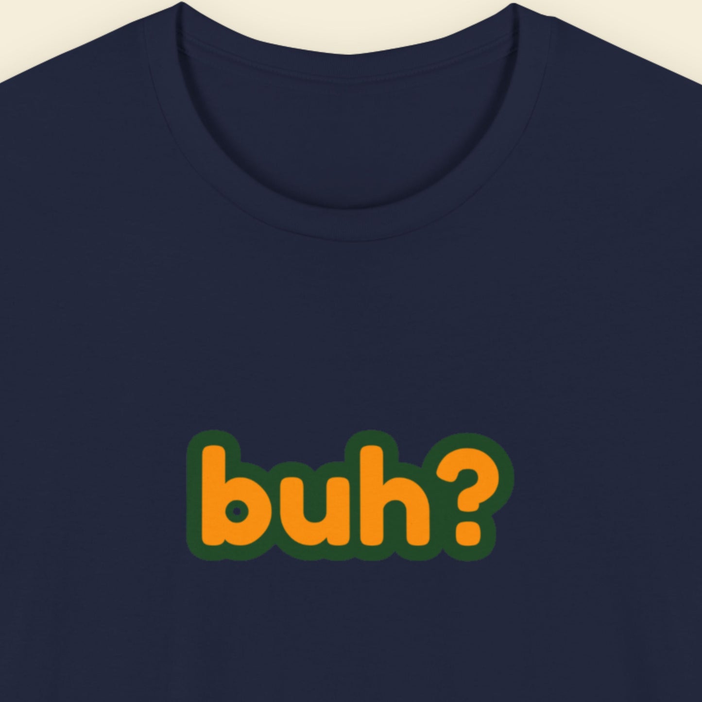 Navy t-shirt with multicolored 'buh?' text on a beige background.
