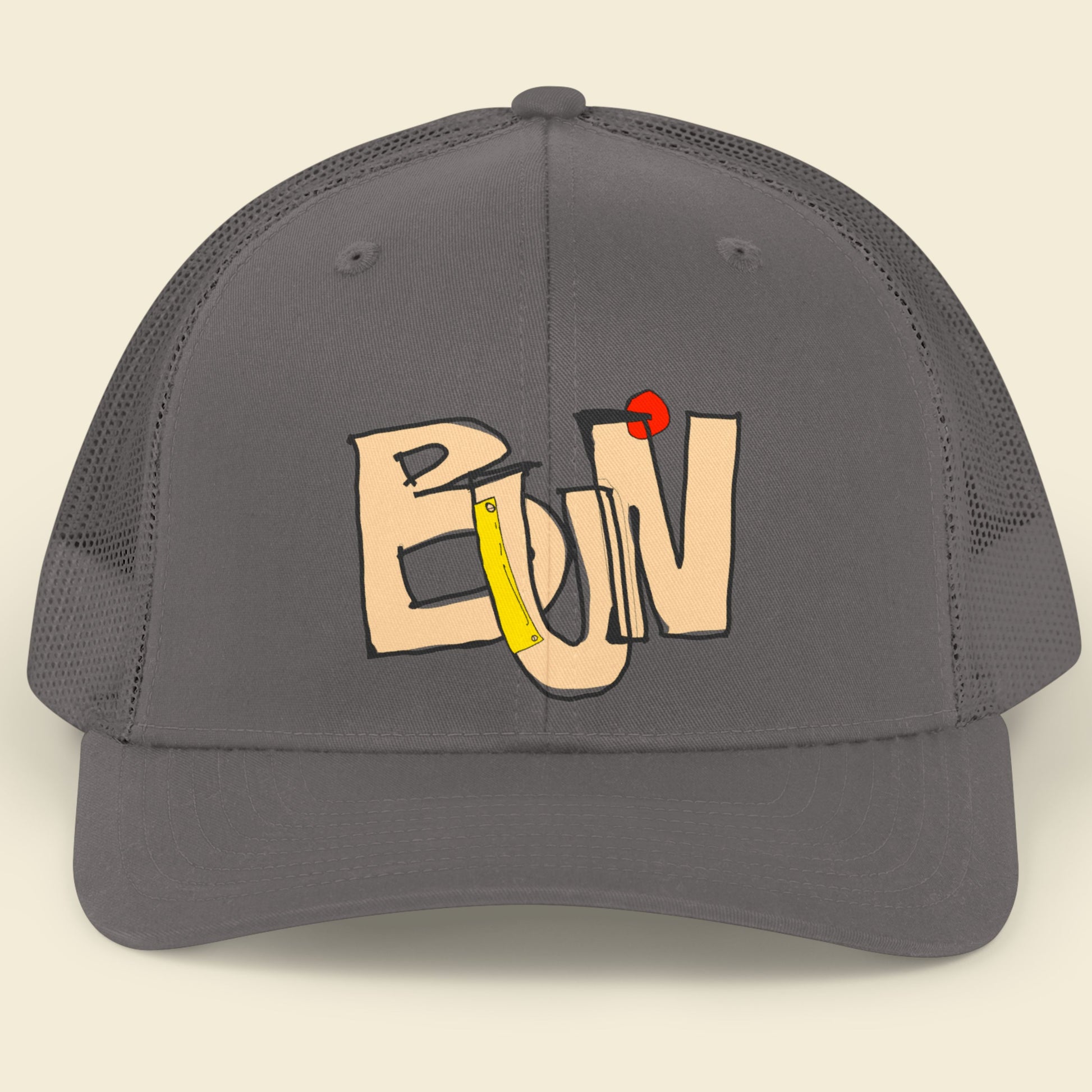 Gray cap with colorful text design on a beige background.