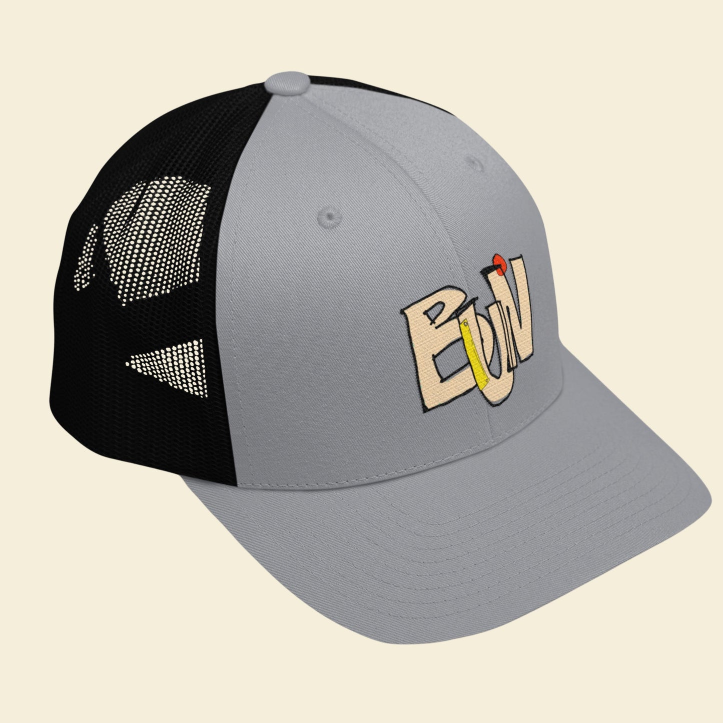 Gray and black cap with a logo on a beige background.