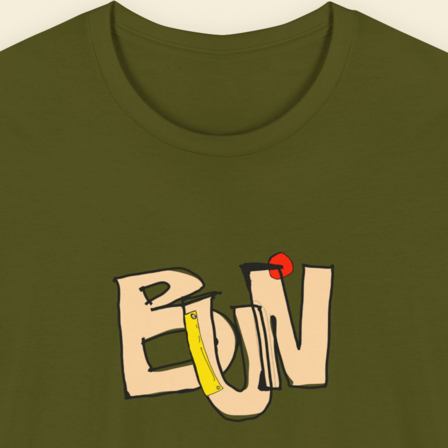 Green t-shirt with a colorful abstract trash graff drawing on a beige background.