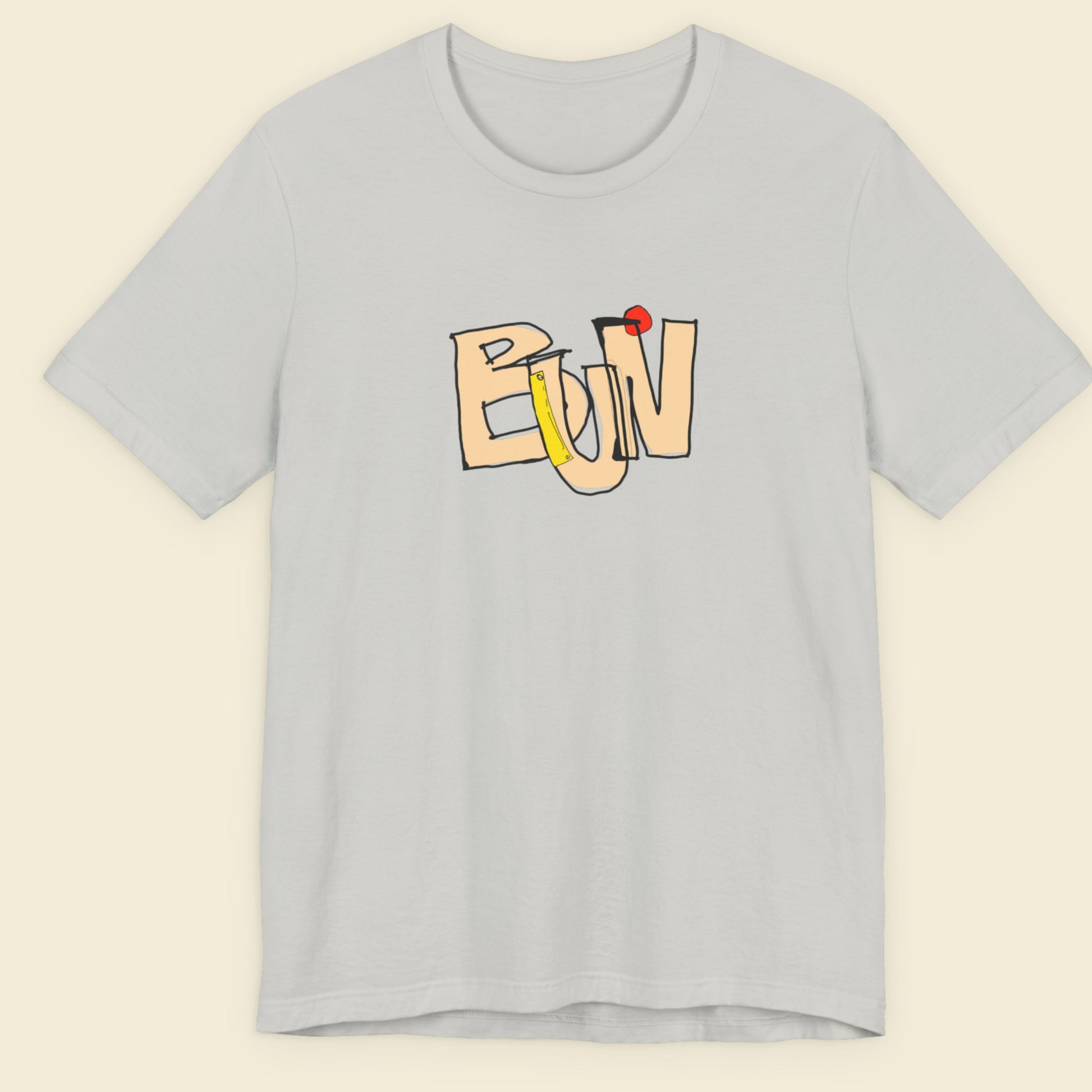 Grey t-shirt with a colorful abstract trash graff drawing on a beige background.