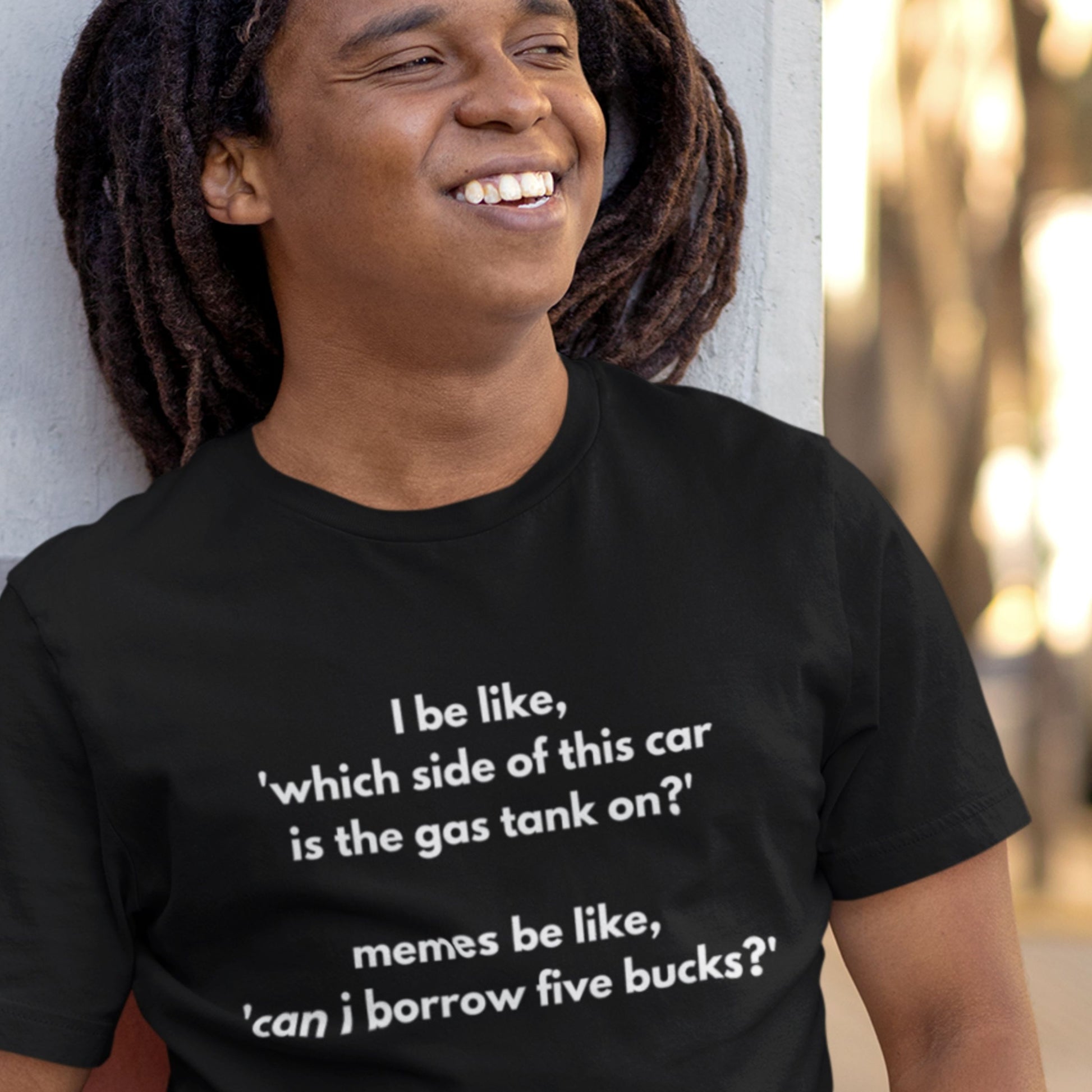 Person wearing a black t-shirt with humorous text design.