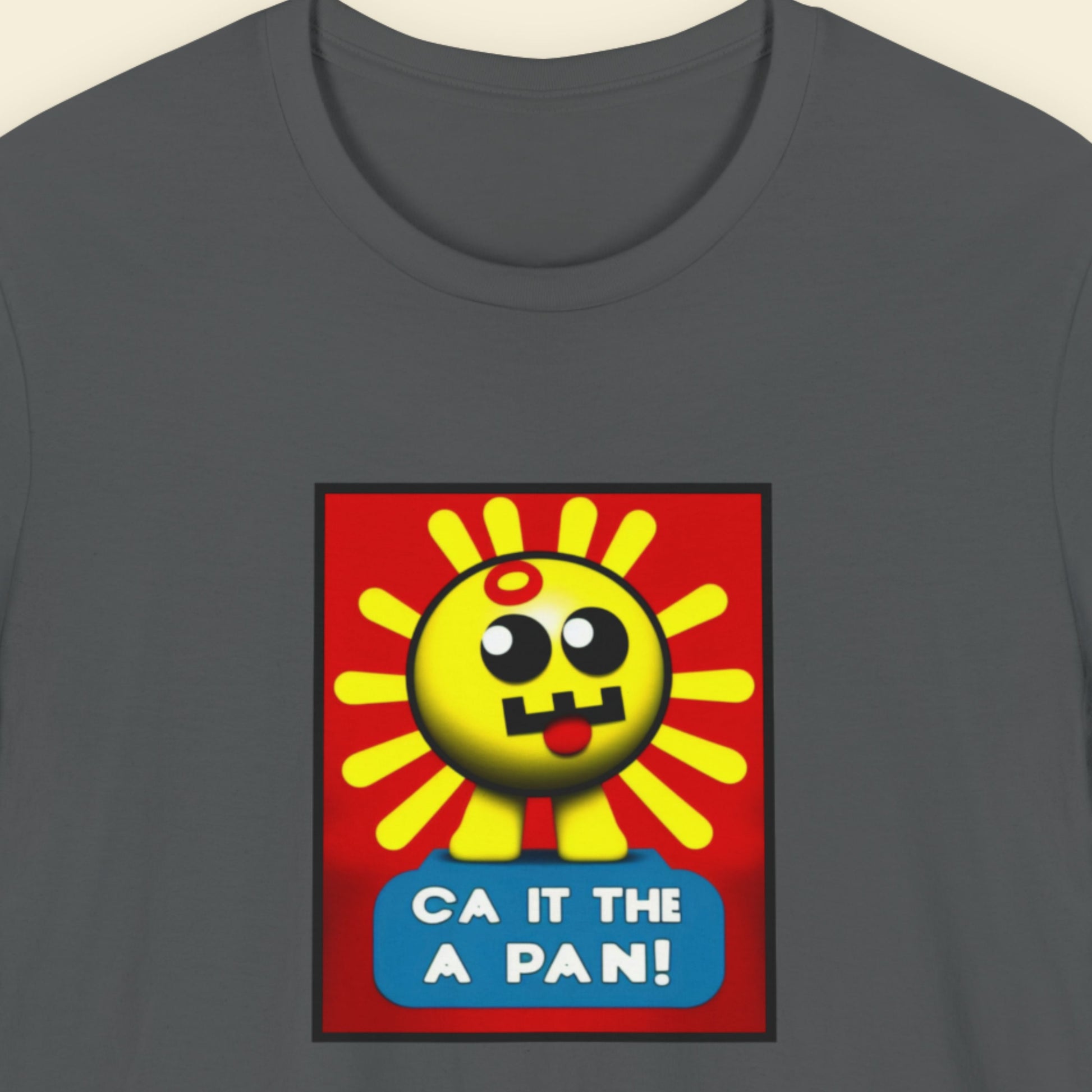 Grey t-shirt with a fun, colorful cartoon illustration on a beige background.