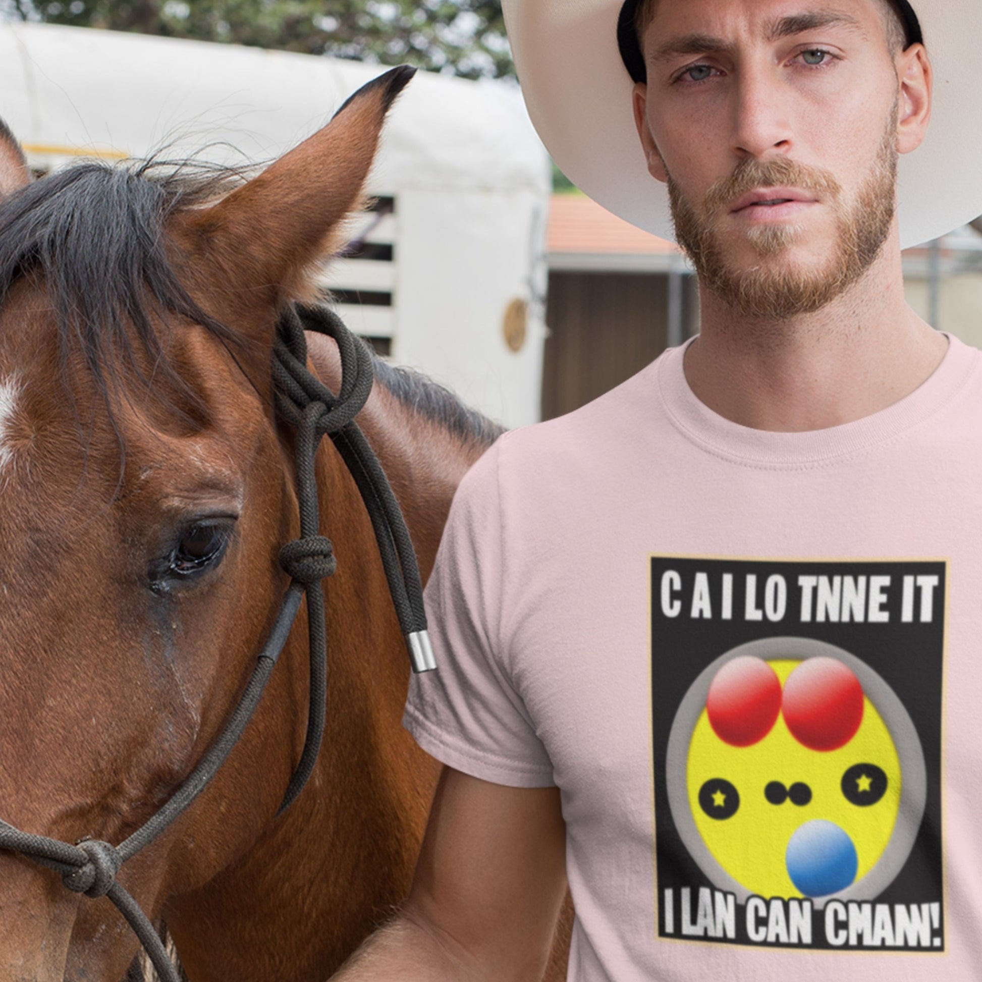 Man wearing a pink t-shirt with a colorful design and text, standing next to a horse.