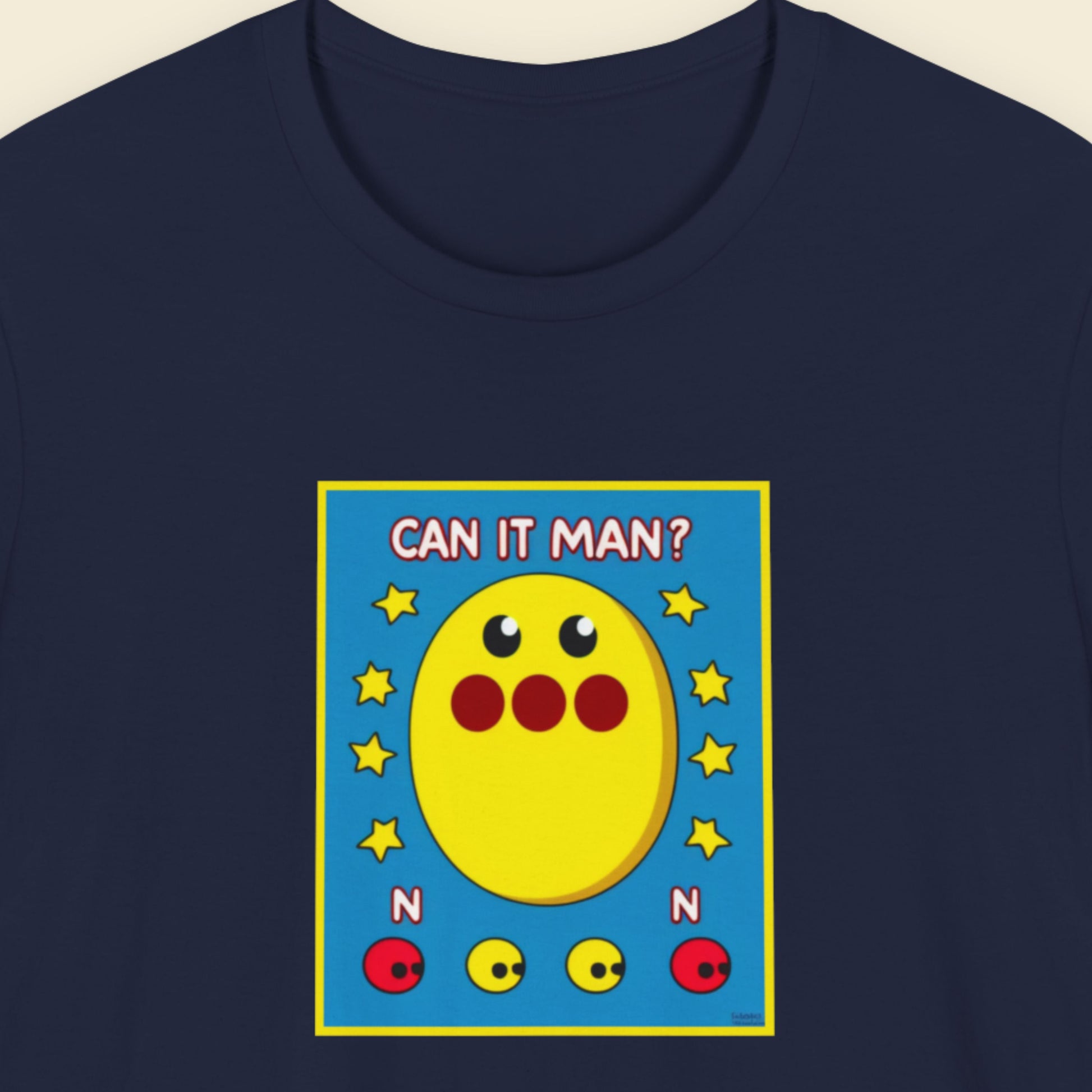 Navy blue t-shirt with a colorful graphic of a yellow character and text 'CAN IT MAN?' on a blue background.