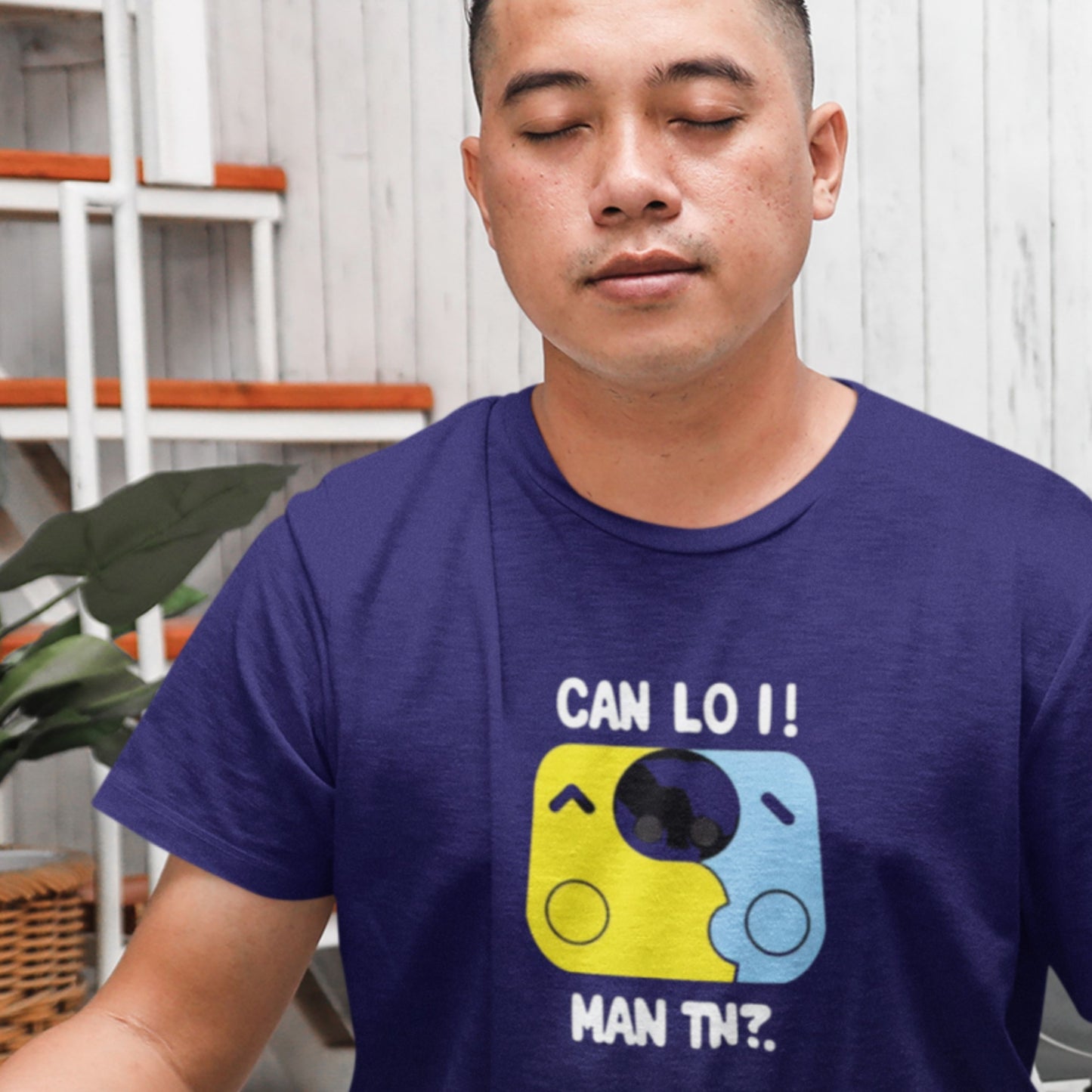Man wearing a blue t-shirt with a graphic design and text.