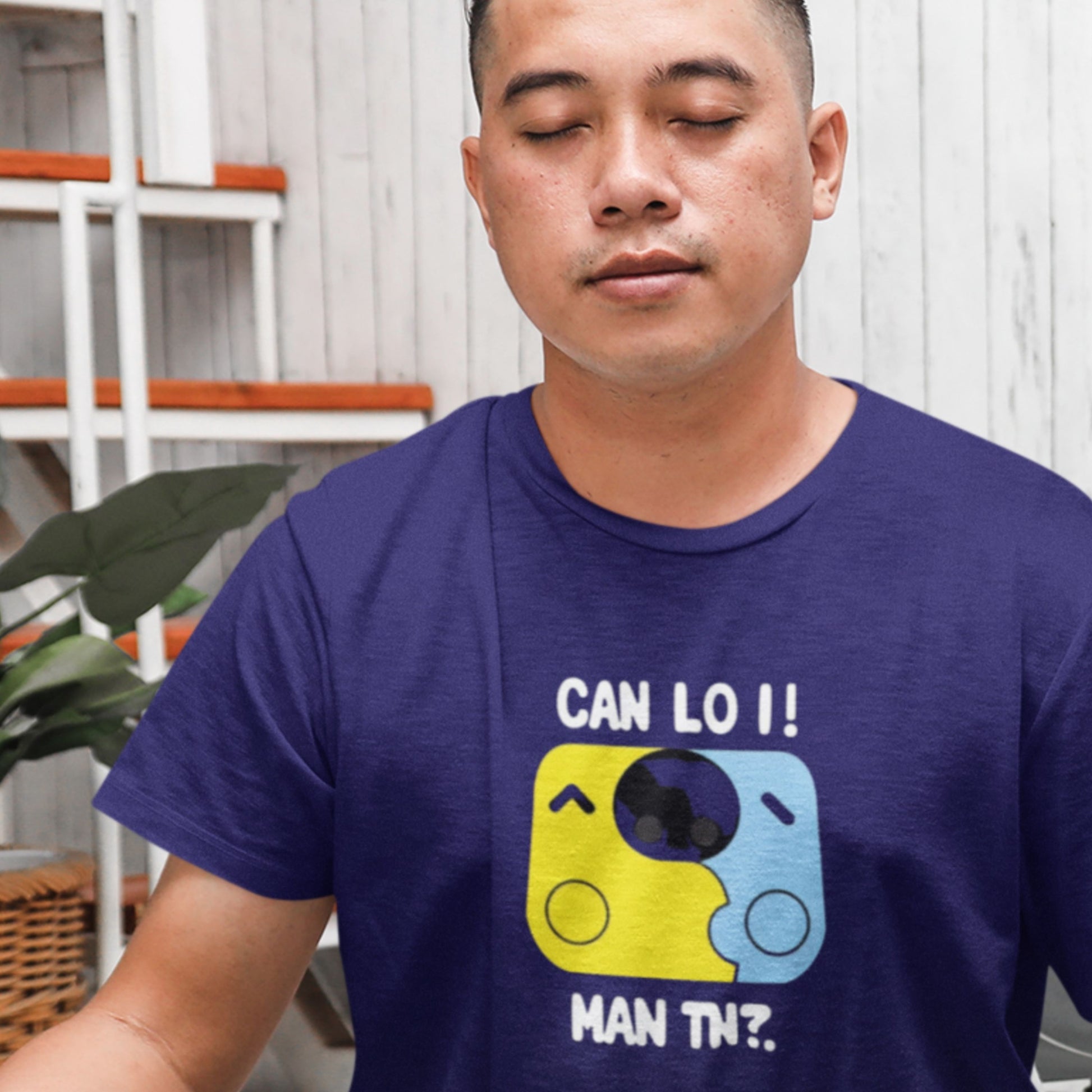 Man wearing a blue t-shirt with a graphic design and text.