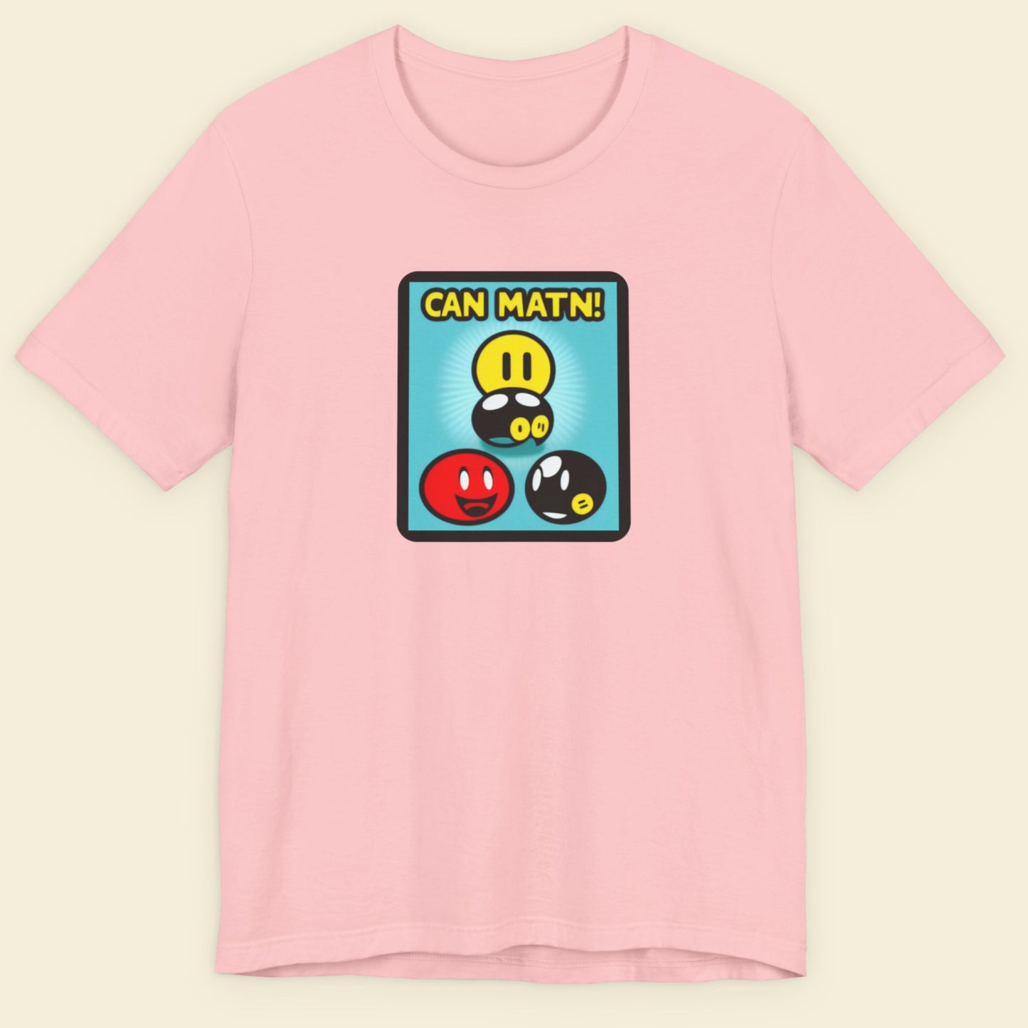 Pink t-shirt with a colorful graphic design on a beige background.