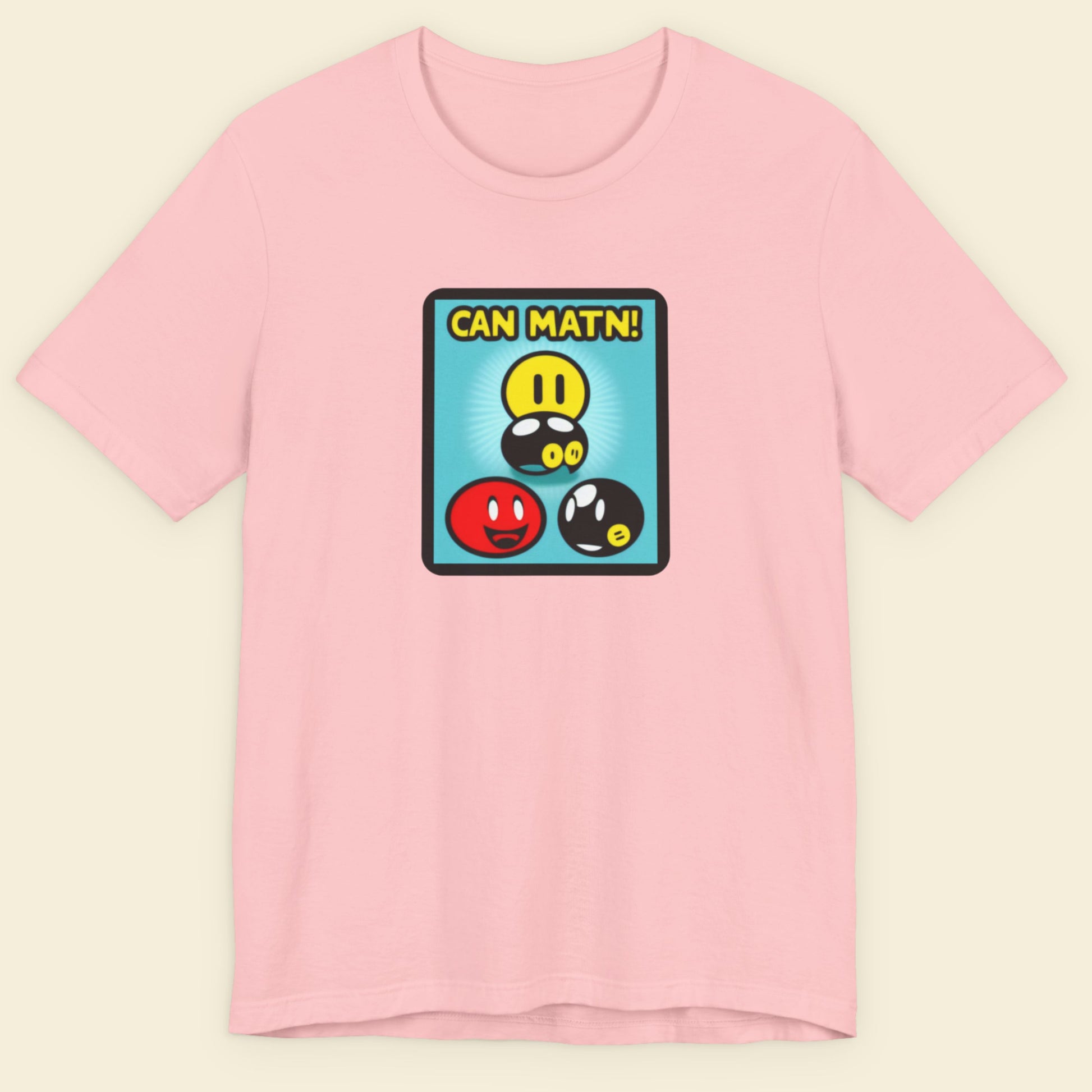 Pink t-shirt with a colorful graphic design on a beige background.