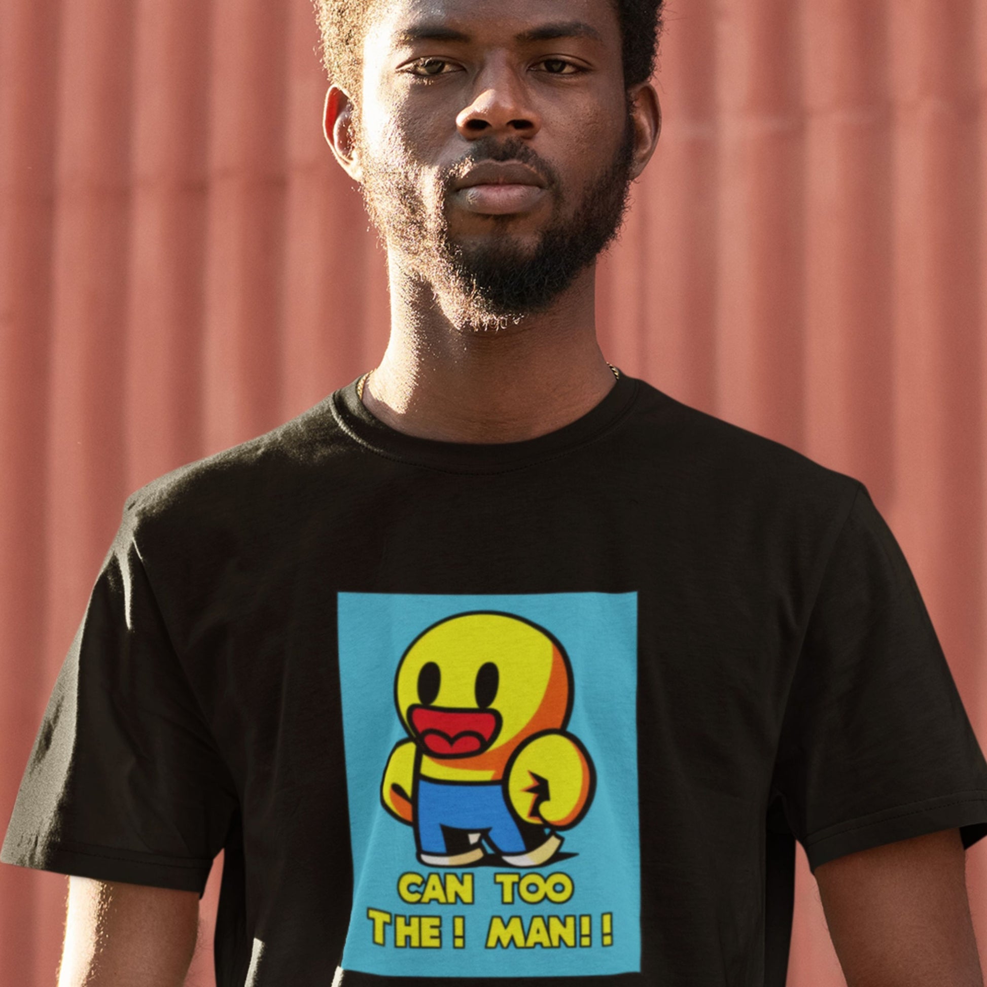 Person wearing a black t-shirt with a colorful graphic and text against a red background.